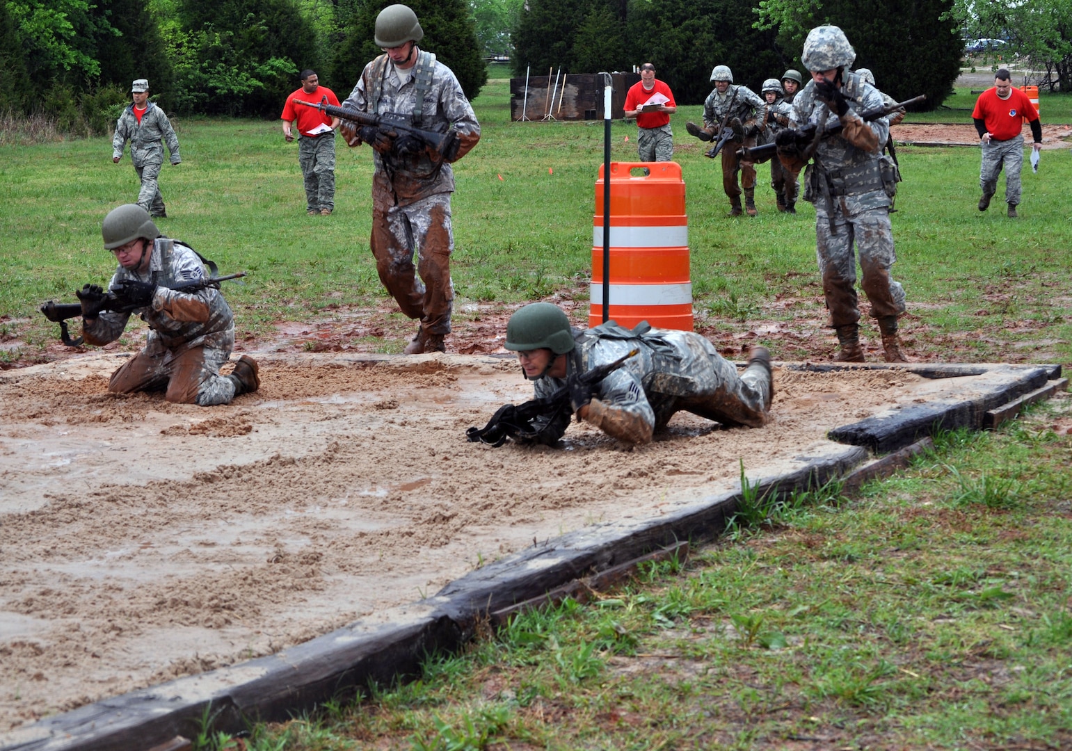 Staff Sergeants Adam Benton and Jarod Williams, 3rd Combat Communications Group hit the dirt to high crawl through the movement course of Team Tactical Challenge at Combat Challenge April 18 at Tinker Air Force Base, Okla.. Senior Airman David Allen and Airman 1st Class David Linden are behind them, waiting their turn. Combat Challenge is the newly incorporated Combat Communications portion of Space Command’s Guardian Challenge. The movement course is comprised of several low/high crawl challenges, teams must transition between each challenge by performing a variety of carries including the fore-and-aft carry, two-man support carry and two-hand seat carry.  Combat Challenge consists of six events taking place April 17-19, with five teams vying to win. (US Air Force photo by Master Sgt. Theresa Shannon)