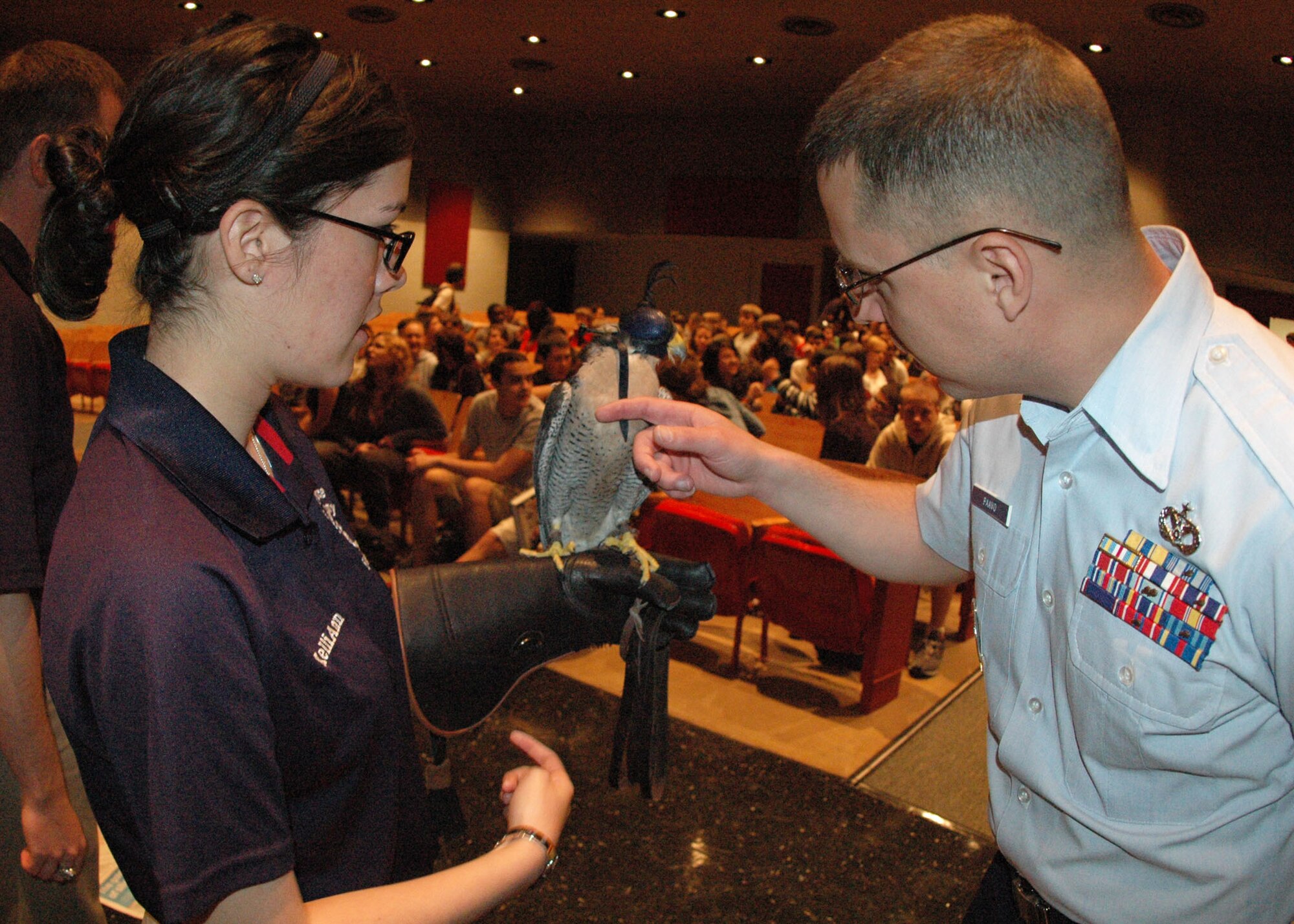 U.S. Air Force Academy Cadet 4th Class Danielle Cortez introduces her school’s peregrine falcon mascot, Havoc, to Air Force Reserve recruiter Tech. Sgt. Brian Paavo during their visit to students at Crestview High School near Eglin Air Force Base, Fla., April 9.  Two visiting cadets spoke to students about their unique extracurricular duties as falconers and how to pursue an Air Force commission through the prestigious military academy in Colorado Springs, Colo.  Helping coordinate the visit, Sergeant Paavo, assigned to nearby Duke Field, Fla., was also on hand to talk to students about opportunities in the Air Force Reserve.  (U.S. Air Force photo/Dan Neely)