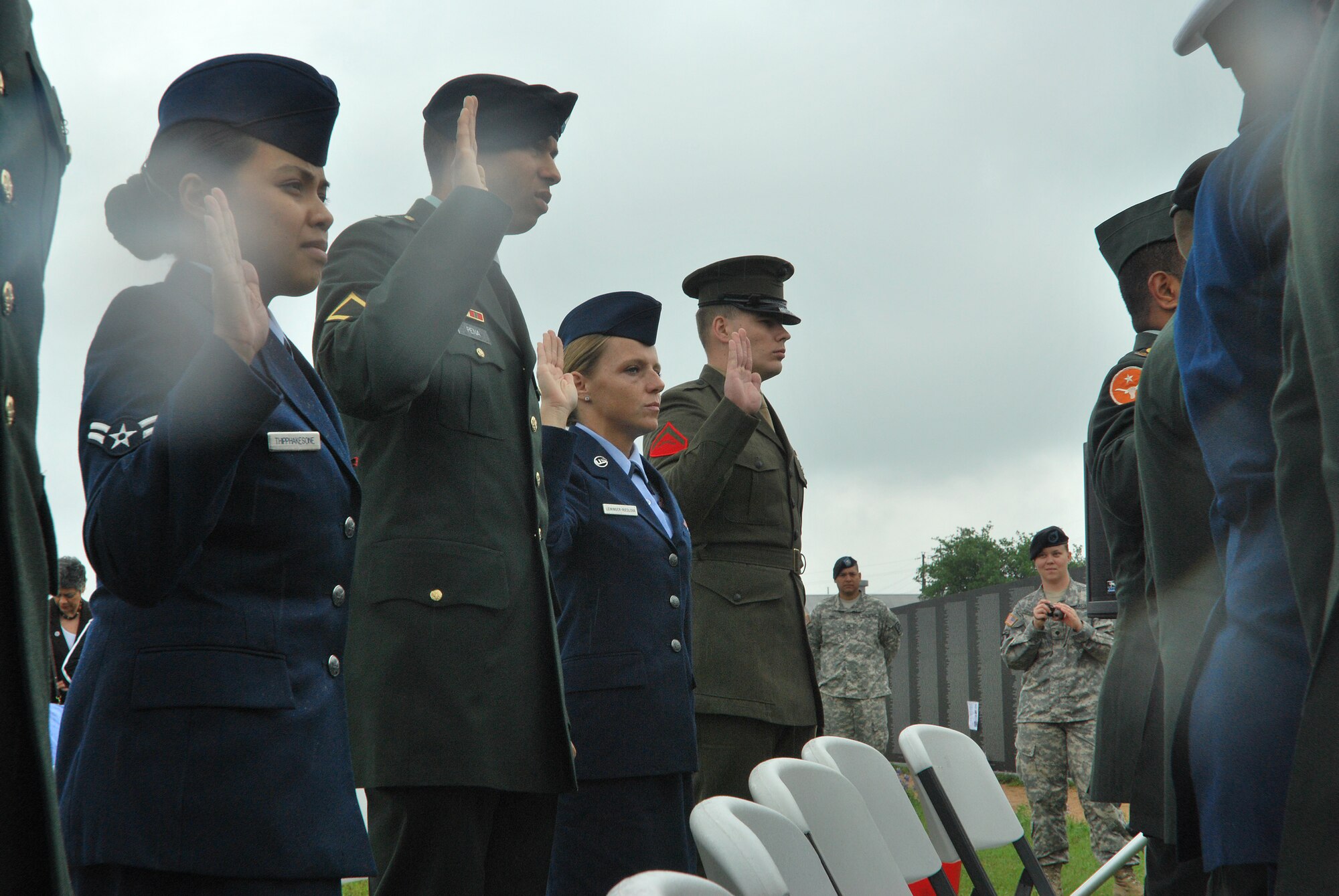 CAMP MABRY, Texas -- Under somber rainy skies, in front of a replica Vietnam Memorial Wall, 13 service members took the Oath of Allegiance to become American citizens
Among the new Americans was Senior Airman Ivanna Leininger-Riedlova, 74th Aerial Port Squadron, Lackland Air Force Base, Texas, who left behind her Czech citizenship
U.S. District Judge Lee Yeakel gave the Oath of Allegiance during the small ceremony, which was part of the weekend-long American Heroes Air Show here.
Airman Leininger-Riedlova said her husband, who is an Army medic, encouraged her to join the Air Force. "I was 32 when I enlisted in May '08 here in San Antonio," she said.
While she acknowledged it was difficult to leave the Czech Republic and never thought she would be an American citizen, she is glad she did. "I have goals," she said. "I want to be a linguist." Airman Leininger-Riedlova said, "I just wanted to be part of fighting for freedom." (U.S. Air Force photo/Airman 1st Class Brian McGloin)

