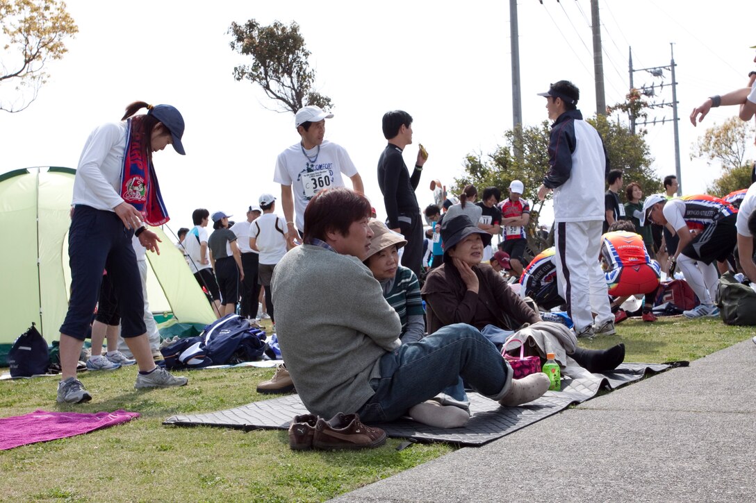 Family and friends sit near the street to cheer on their loved ones during the 44th annual Kintai Marathon at the IronWorks Gym here April 18.  Bystanders posted up their tents, blankets, and lawn chairs while they listened to music, soaked up the sun and socialized.