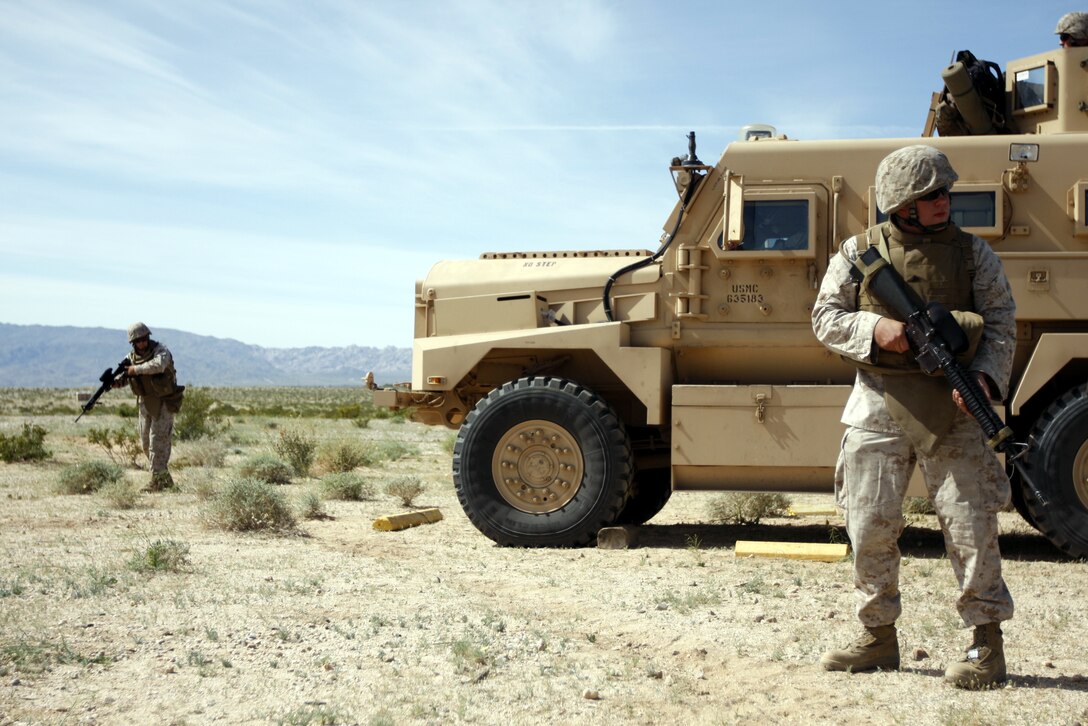 MARINE CORPS AIR GROUND COMBAT CENTER TWENTYNINE PALMS, Calif. - Cpl. Ty Baker [left] and Cpl. Adam Randall, motor transportation mechanics with Motor Transportation Company, Marine Wing Support Squadron 374, scan for improvised explosive devices April 20 at Combat Center Range 800. The newly-established range is meant for tenant units only.