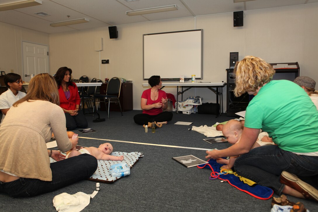 26th Marine Expeditionary Unit spouses learn how to give their newborns a message during a class April 19, 2010. The 26th MEU Family Readiness Program aims to enable every Marine and sailor to complete every assigned mission without the stress of being unsure about the well-being of loved ones on the home front. The infant massage instruction and other family wellness courses are just some of the ways 26th MEU encourages family readiness.