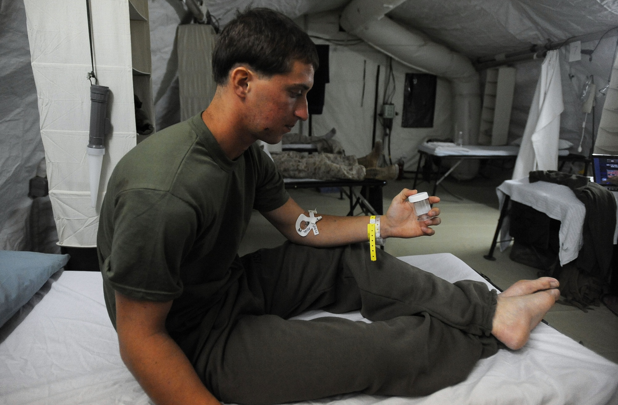 Marine Lance Cpl. Chris Spadaccini, a squad-automatic-weapons gunner assigned to 1/6 Marine Expeditionary Force, Bravo Company, 3rd Platoon, holds the bullet that was removed from his shoulder and tells the story at the 451st Expeditionary Aeromedical Evacuation Squadron, Detachment 1 Contingency Aeromedical Staging Facility, April 13, 2010, at Camp Bastion, Afghanistan. (U.S. Air Force photo/Staff Sgt. Manuel J. Martinez/released)
