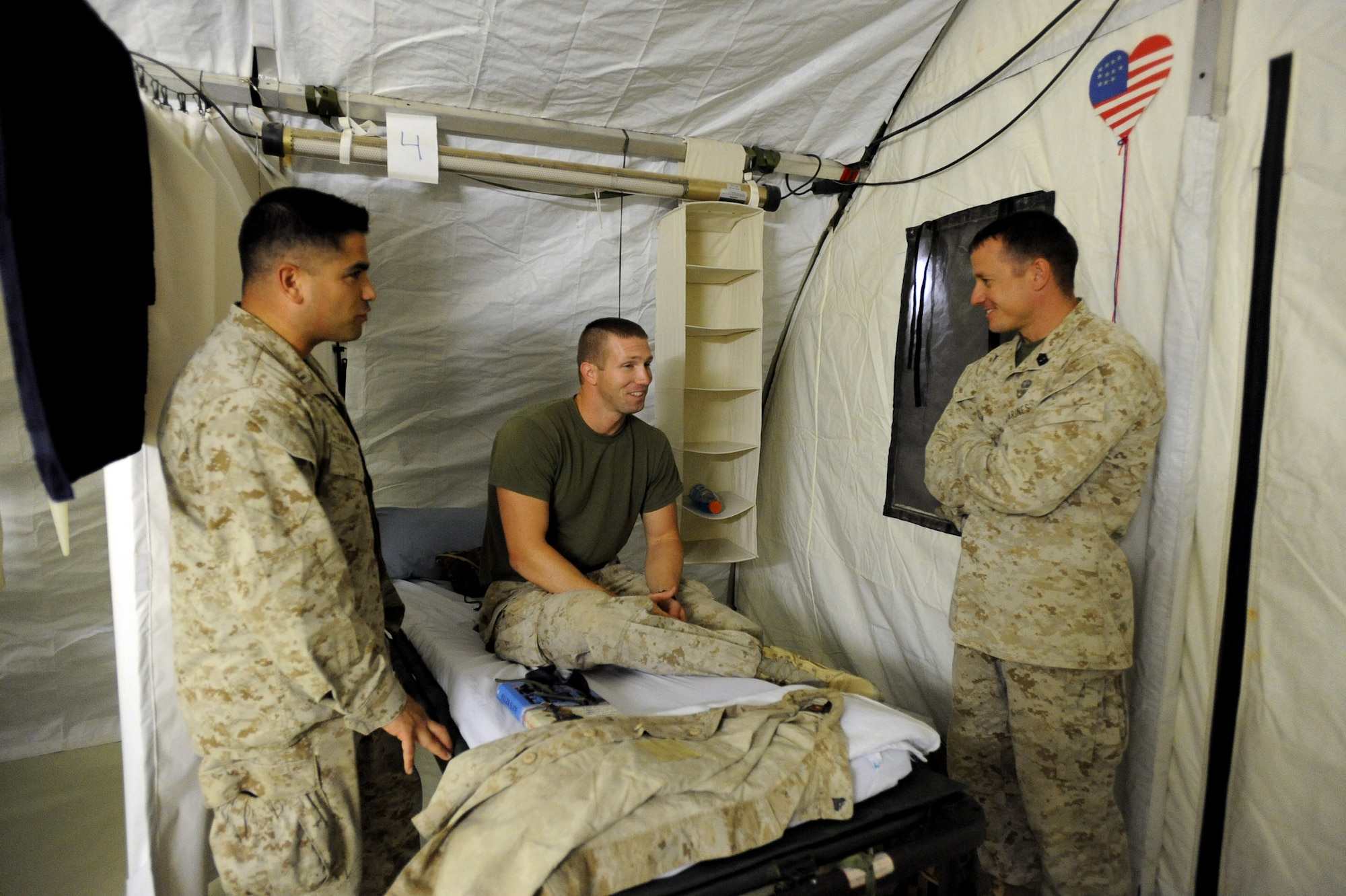 Marine Capt. Mauro Sanchez, left, and Marine First Sgt. Ingo Rasch, right, both assigned to 3rd Recon Battalion, 3rd Force Recon, visit with Marine Cpl. Keth Moss in the 451st Expeditionary Aeromedical Evacuation Squadron, Detachment 1 Contingency Aeromedical Staging Facility April 13, 2010, at Camp Bastion. (U.S. Air Force photo/Staff Sgt. Manuel J. Martinez/released) 