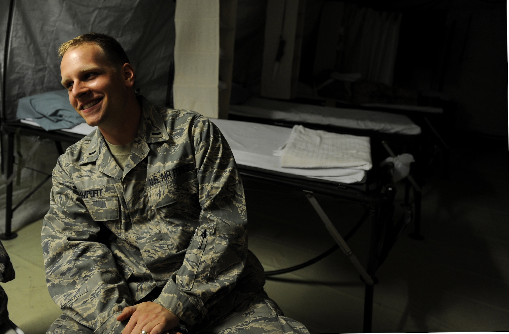 First Lieutenant Sean Amport, a registered nurse assigned to the 451st Expeditionary Aeromedical Evacuation Squadron, Detachment 1 Contingency Aeromedical Staging Facility, talks with his co-workers while patients sleep, April 12, 2010, at Camp Bastion, Afghanistan. ?I have gotten a chance to not only serve in my traditional assessment role as a nurse, but I have actually gotten a chance to hang out, watch movies and get to know our patients,? Lieutenant Amport said. ?Seeing what these Marines go through and getting to help them has given me new insight on myself and I know I will go home a better person for having had the chance to serve my fellow servicemembers.? (U.S. Air Force photo/Staff Sgt. Manuel J. Martinez/released)
