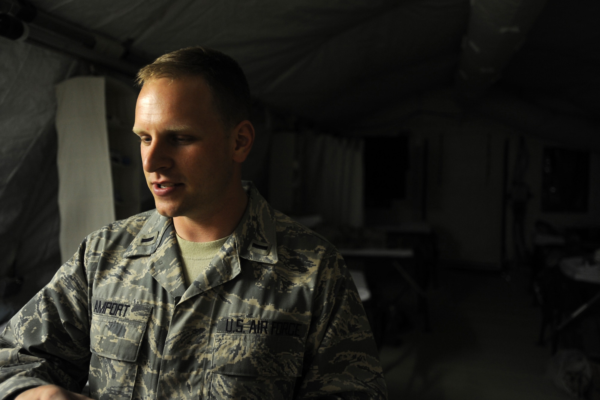 First Lieutenant Sean Amport, a registered nurse assigned to the 451st Expeditionary Aeromedical Evacuation Squadron, Detachment 1 Contingency Aeromedical Staging Facility, talks with his co-workers while patients sleep, April 12, 2010, at Camp Bastion, Afghanistan. (U.S. Air Force photo/Staff Sgt. Manuel J. Martinez/released)

