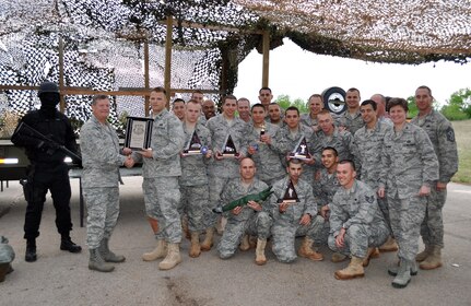 Maj. Gen. Richard Webber, 24th Air Force commander presents the 5th Combat Communications Group, Robins AFB, Ga. Combat Challenge team their finalist trophy at the Combat Challenge Awards banquet held at Tinker AFB, April 19. The 5th CCG is one of two finalists to attend the Guardian Challenge Awards May 21. Combat Challenge is the newly incorporated Combat Communications portion of Air Force Space Command’s Guardian Challenge. Combat Challenge consisted of six events that took place April 17-19. (US Air Force photo by Master Sgt. Theresa Shannon)