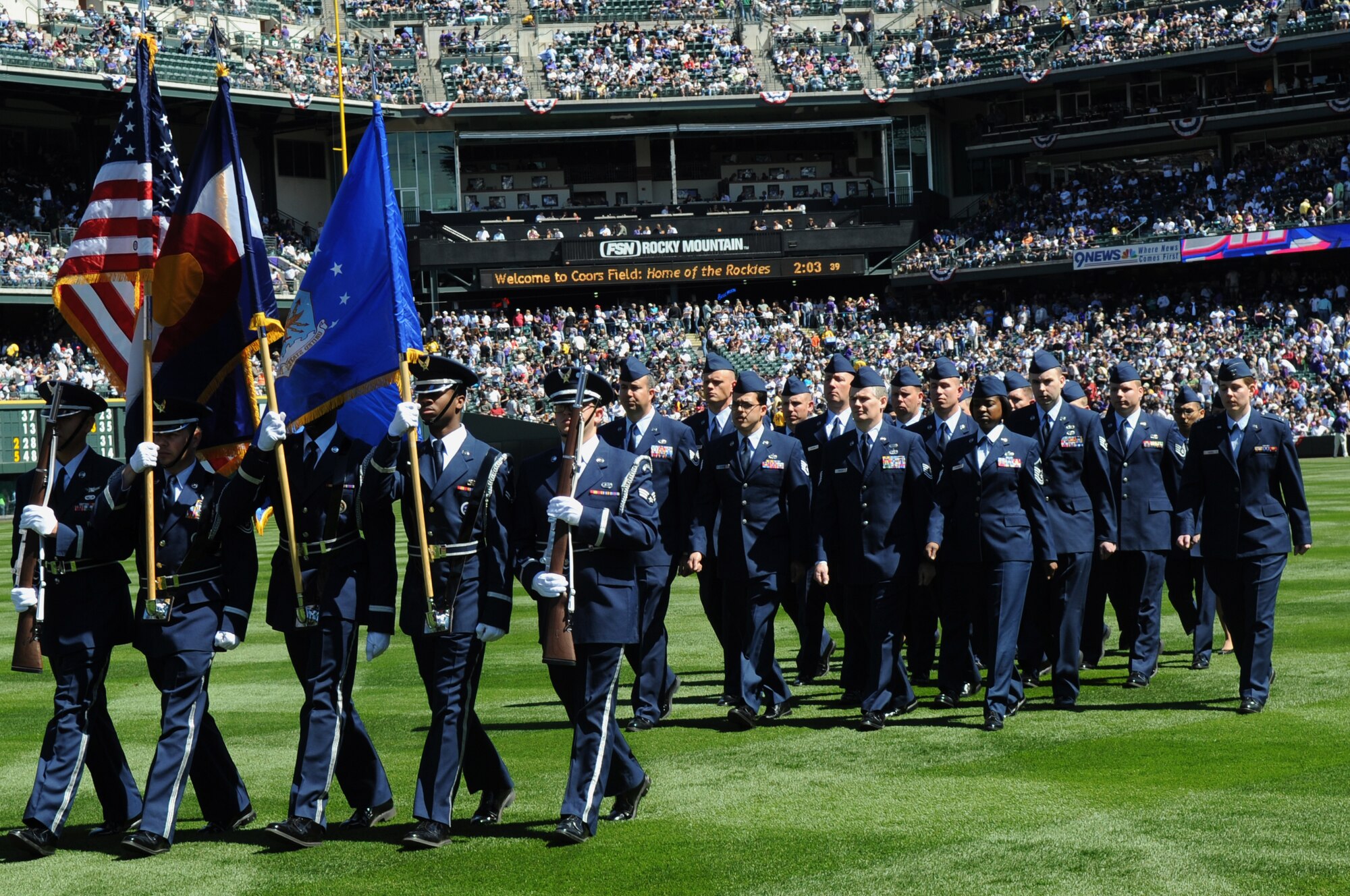 DENVER, Colo. -- Airmen from Colorado recruiting stations, Buckley Air Force Base and Peterson Air Force Base depart Coors Field in front of a 45,509-person crowd April 9. Members from all services performed ceremonial guardsmen duties during the Colorado Rockies Opening Day festivities. (U.S. Air Force photo by Airman 1st Class Marcy Glass)