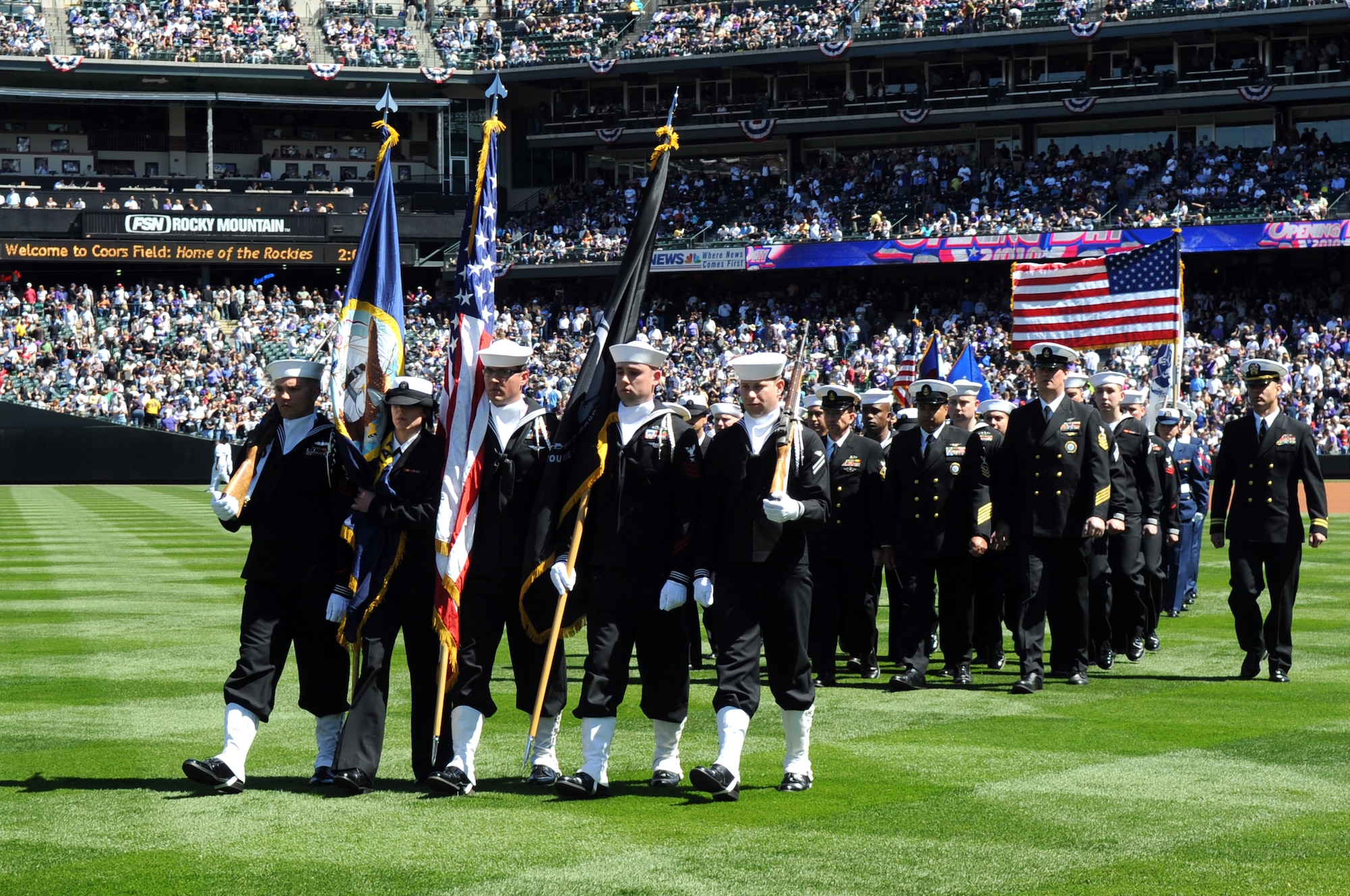 DENVER, Colo. -- Sailors of the Navy Recruiting District Denver and Buckley Air Force Base march with pride from Coors Field and a crowd of 45,509 people April 9. (U.S. Air Force photo by Airman 1st Class Marcy Glass)
