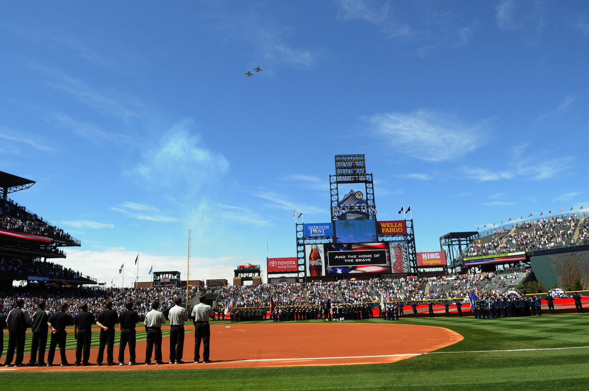 DENVER, Colo. -- A crowd of 45,509 people watch two Navy EA-18G Growlers fly over Coors Field during Colorado Rockies Opening Day April 9. The Rockies won the opener against the San Diego Padres 7-0. (U.S. Air Force photo by Airman 1st Class Marcy Glass)