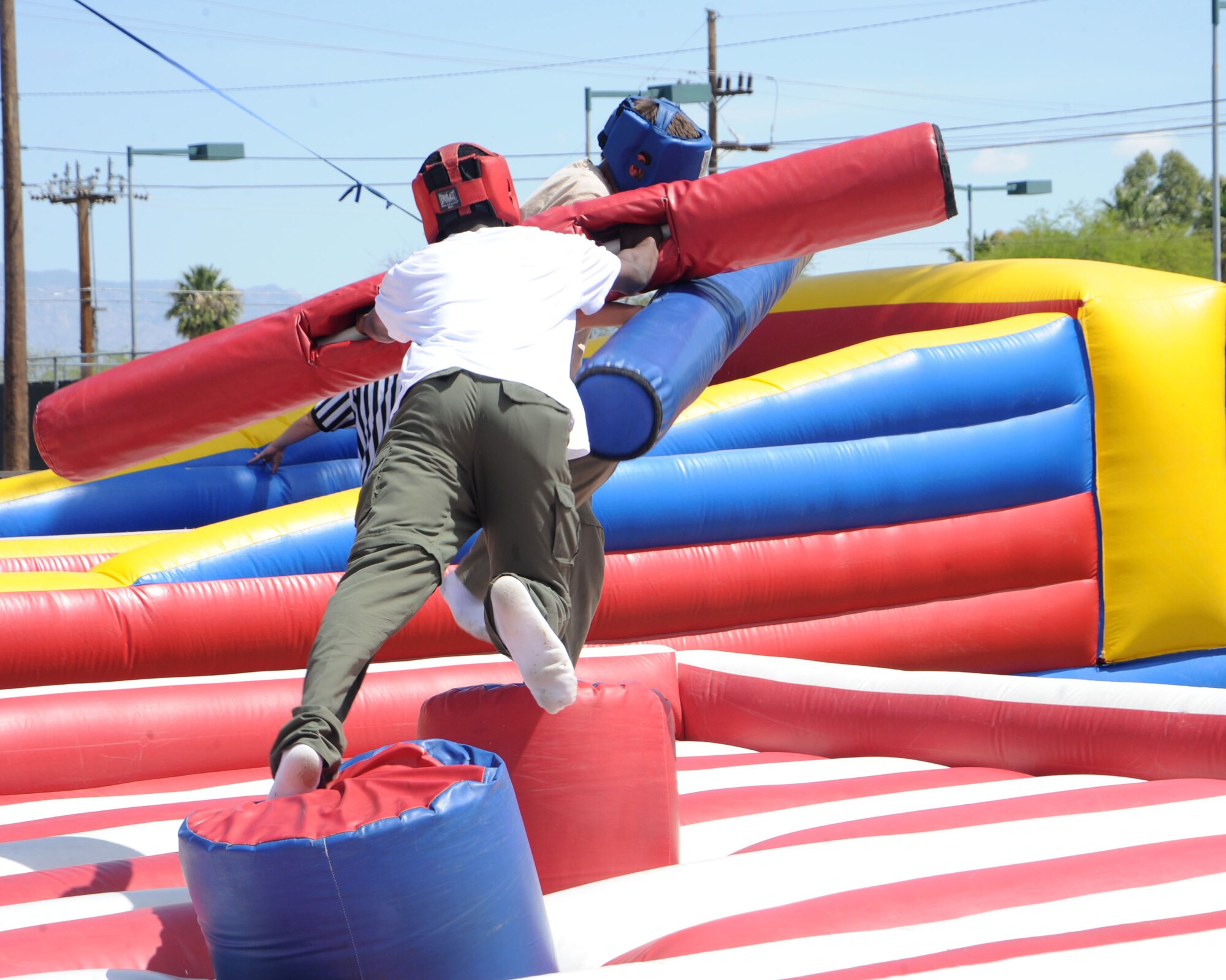 Children joust with pugil sticks at the annual DM-50 Picnic held at Bama Park here April 17. The picnic offered Airmen and their families free food and various activities, including a mechanical bull ride, car show, fire truck display and children’s games. (U.S. Air Force photo/ Airman Jerilyn Quintanilla) 