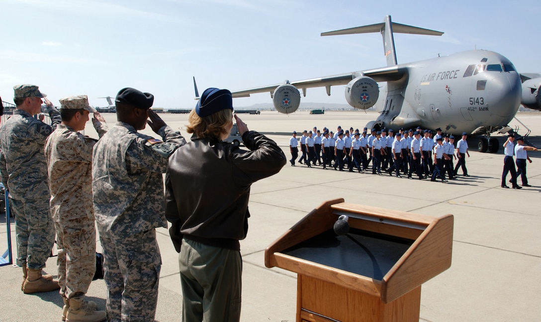 Reviewing officials (from right) Col. Mary Aldrian, 452nd Air Mobility Wing Vice Commander, Col. Norman Green, Army Reserve 304th Sustainment Brigade Commander, Lt. Ed Giron, Navy Operational Support Center Moreno Valley Executive Officer and Chief Agustin Huerta, 452 AMW Command Chief, salute as the second of two squadrons of high school JROTC students pass the reviewing stand during the pass and review held at March ARB April 10. (U.S. Air Force photo by Tech. Sgt. Joe Davidson)