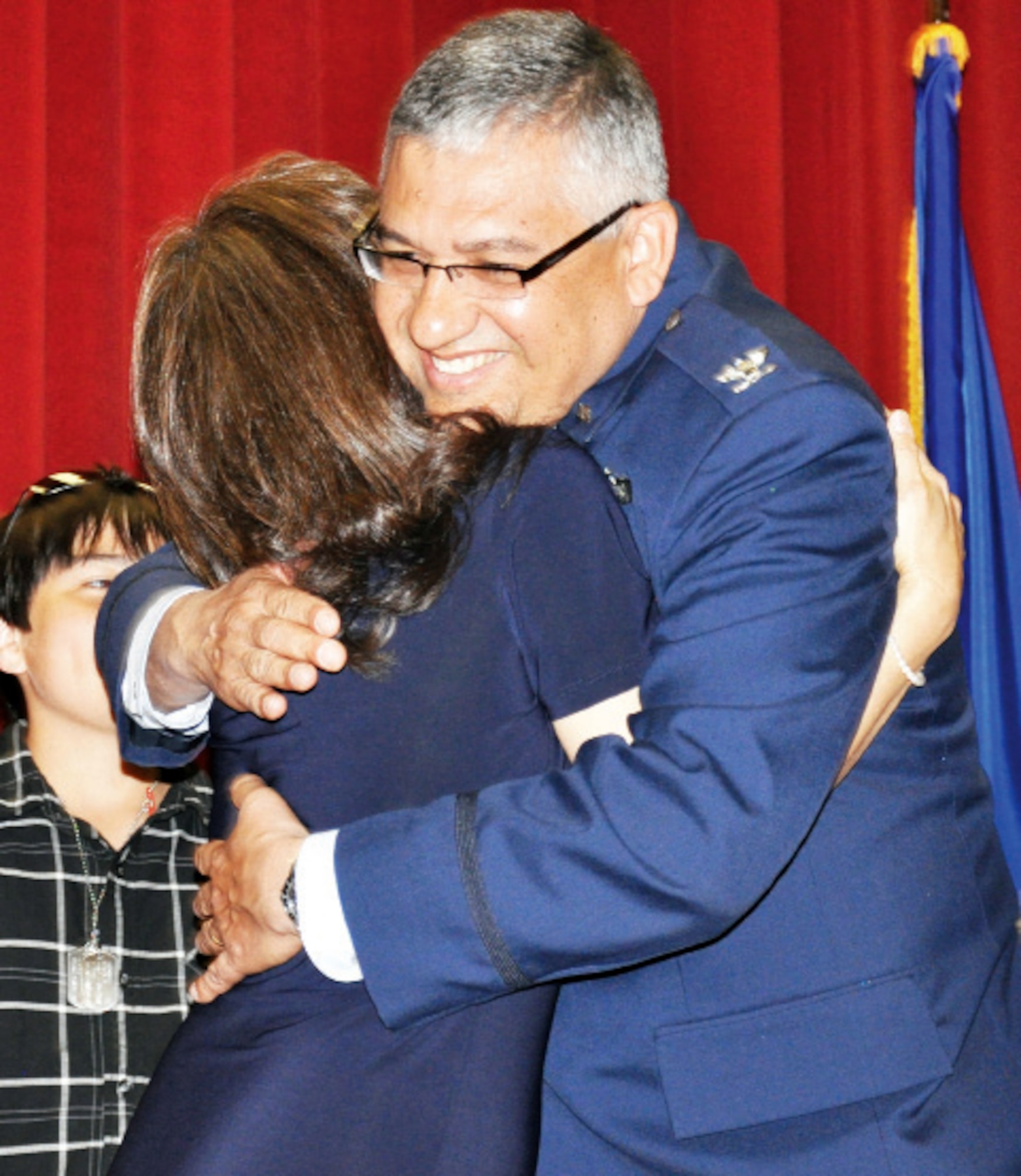 Eddie Sanchez, commander of the 452nd Aeromedical Staging Squadron, hugs his wife, Maria Sanchez, during his promotion to colonel March 28 in the Cultural Resources Center. Colonel Sanchez’s wife, mother and two children pinned on his new insignia. Colonel Sanchez has been in the Air Force since 1978 and at March Air Reserve Base since Aug. 2008. During the ceremony, Colonel Sanchez gave a special thank you to his uncle, a Vietnam veteran whose heroism was recognized with the Purple Heart and a Bronze Star with Valor. (U.S. Air Force photo)