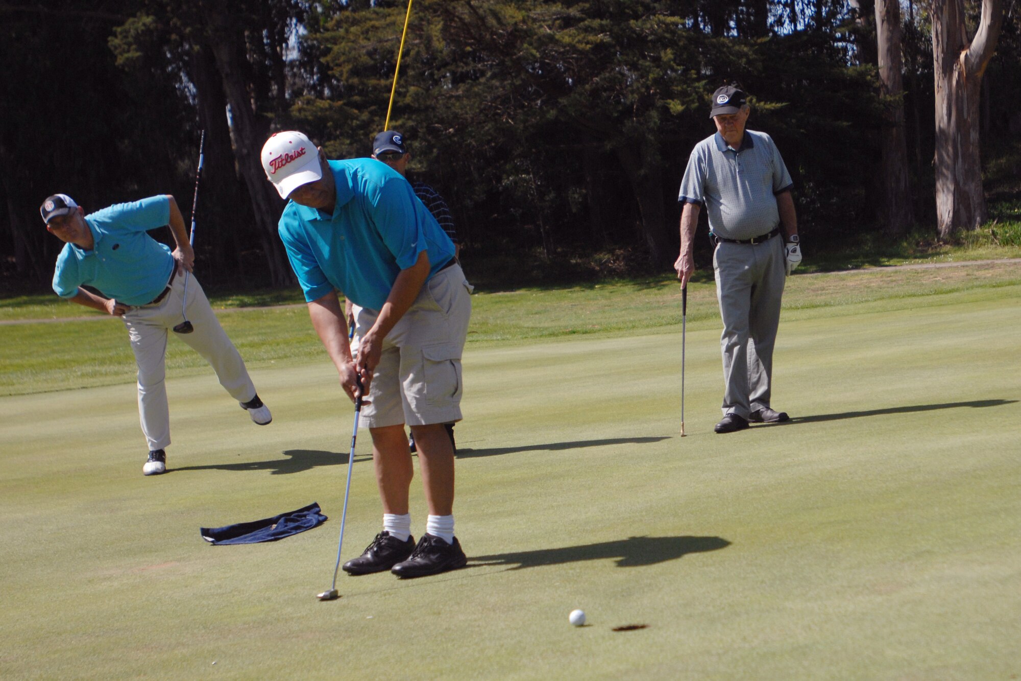 VANDENBERG AIR FORCE BASE, Calif. – David Barcelona, putts the ball toward the hole, as Dave Wilhite and Hal Robinson look on, during the Spring Open Golf Tournament located at the Marshallia Ranch Golf Course here Sunday, April 18, 2010. The Spring Open was a stroke play tournament which is where the winner is the person with the lowest score. (U.S. Air Force photo/Senior Airman Christopher Hubenthal)