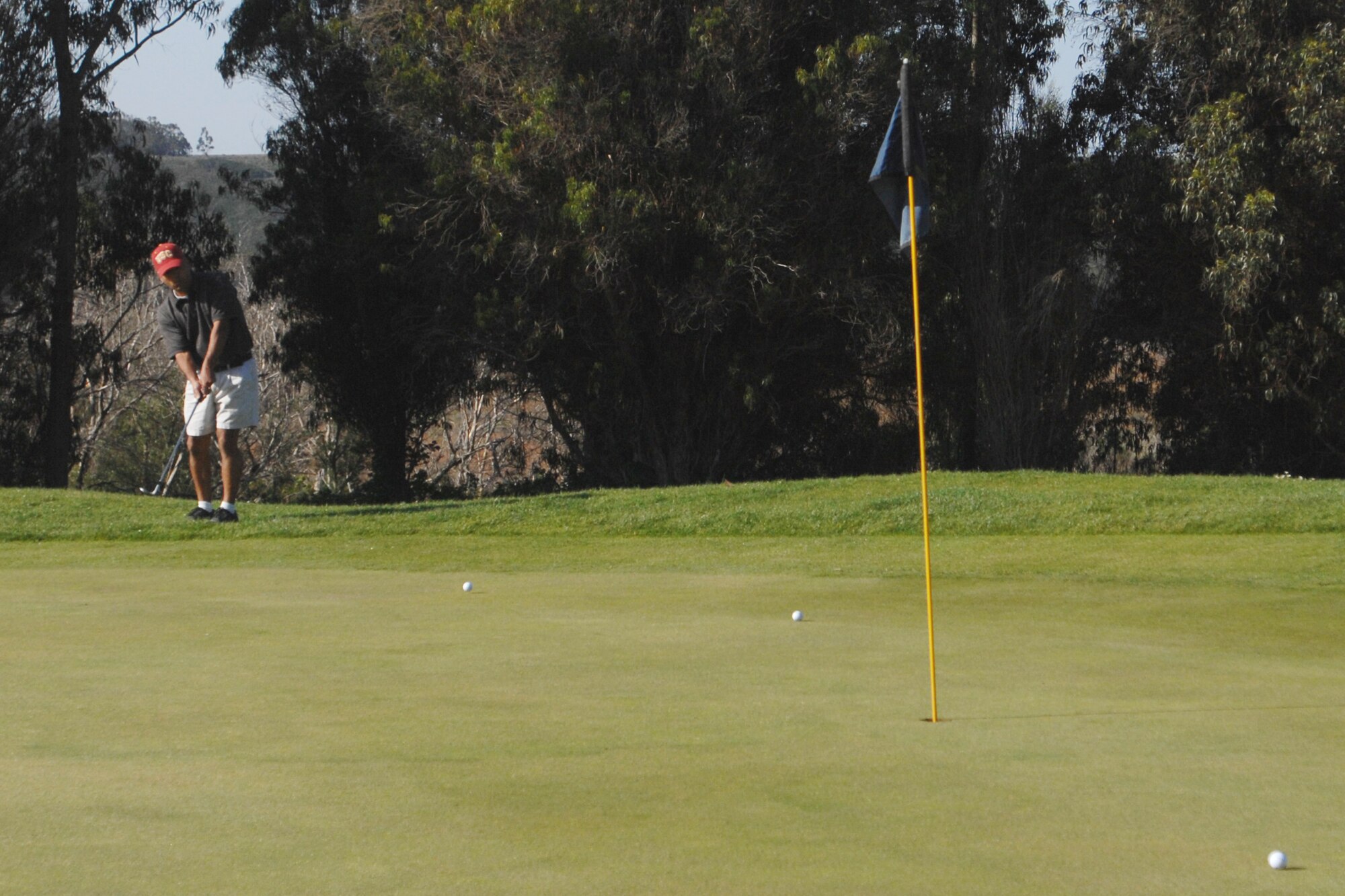 VANDENBERG AIR FORCE BASE, Calif. – Staff Sgt. Pedro Landa, of the 30th Force Support Squadron, putts the ball toward the hole during the Spring Open Golf Tournament at Marshallia Ranch Golf Course here Sunday, April 18, 2010. Approximately 50 players attended the Spring Open. (U.S. Air Force photo/Senior Airman Christopher Hubenthal)