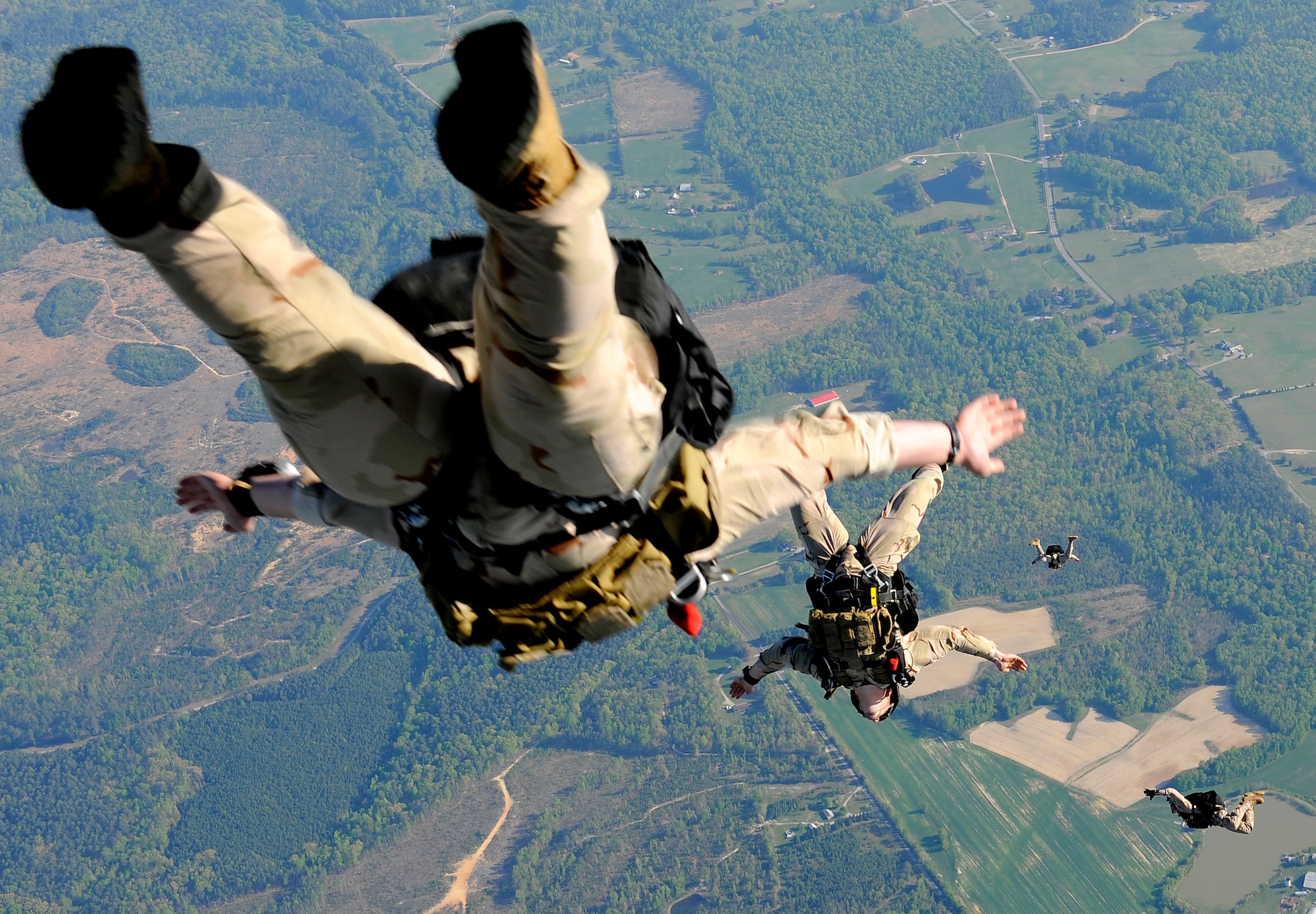 Navy SEALs jump from the ramp of a C-17 Globemaster III over Fort Picket Maneuver Training Center, Va., April 15.  The jump was part of joint training exercise with the 517th Airlift Squadron from Elmendorf Air Force Base, Alaska. The training consisted of high altitude, high opening and high altitude, low opening jumps between 5,000 and 12,500 feet. (Air Force photo by Staff Sgt. Brian Ferguson)