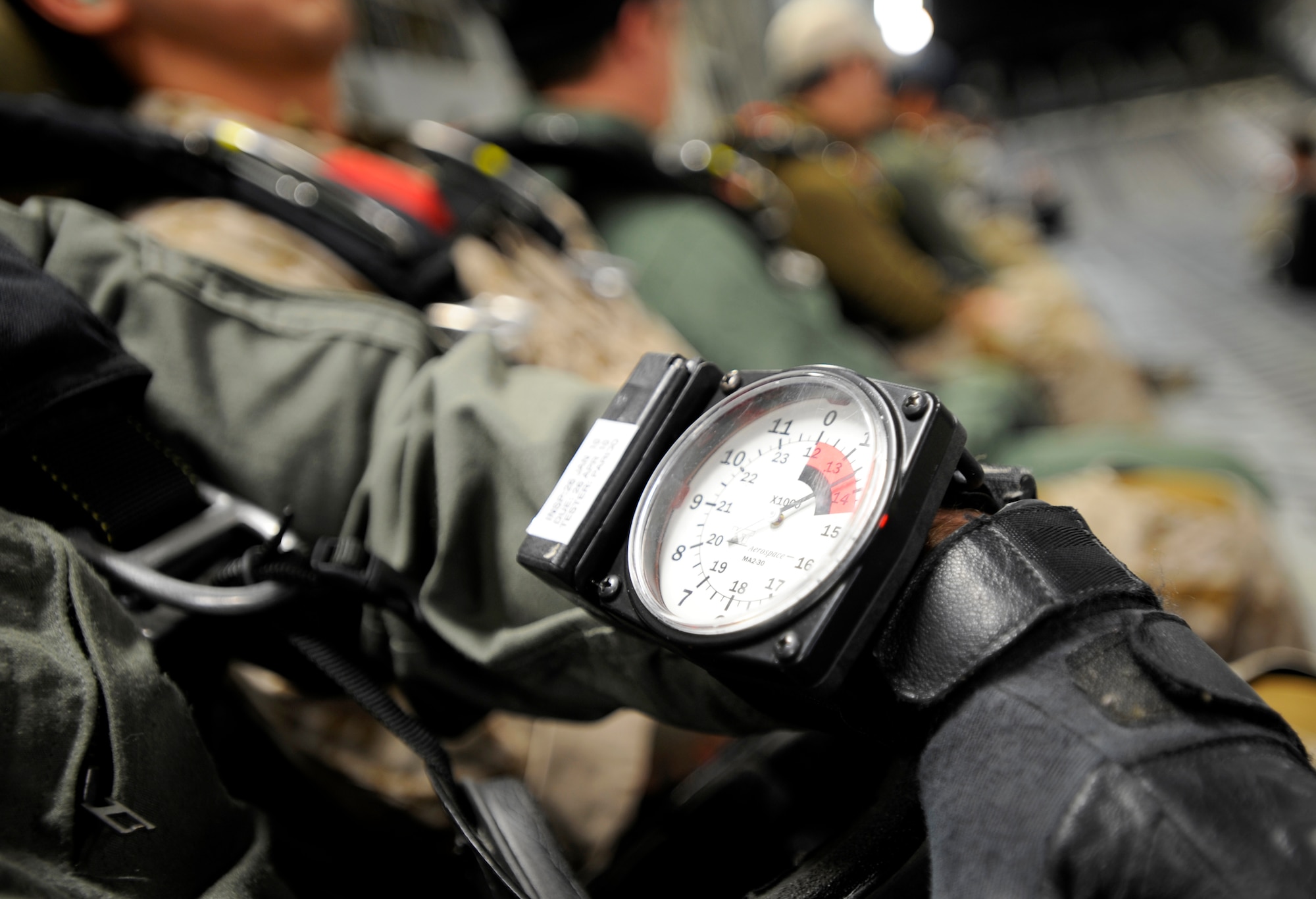 A Navy SEAL checks his altimeter before jumping from a C-17 Globemaster III over Fort Picket Maneuver Training Center, Va., April 15.  The jump was part of joint training exercise with the 517th Airlift Squadron from Elmendorf Air Force Base, Alaska. The training consisted of high altitude, high opening and high altitude, low opening jumps between 5,000 and 12,500 feet. (Air Force photo by Staff Sgt. Brian Ferguson)