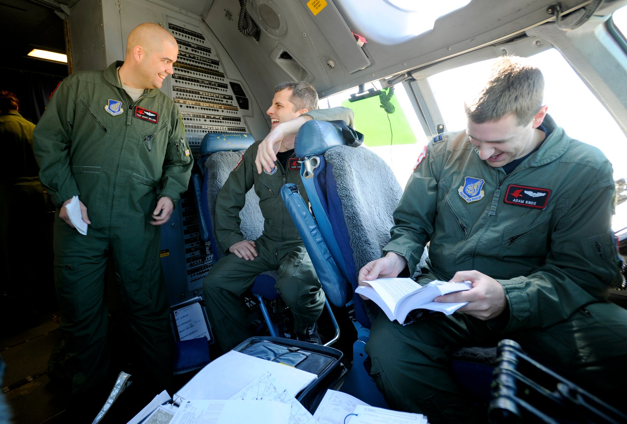 While on the ground, Tech. Sgt. Marc Nelson, left, Capt. Gabe Parkison, center, and Capt. Adam Knox take a minute to relax after dropping a group of Navy SEALs from a C-17 Globemaster III at Fort Picket Maneuver Training Center, Va., April 15. The jump was part of joint training exercise with the 517th Airlift Squadron from Elmendorf Air Force Base, Alaska. The training consisted of high altitude, high opening and high altitude, low opening jumps between 5,000 and 12,500 feet. (Air Force photo by Staff Sgt. Brian Ferguson)
