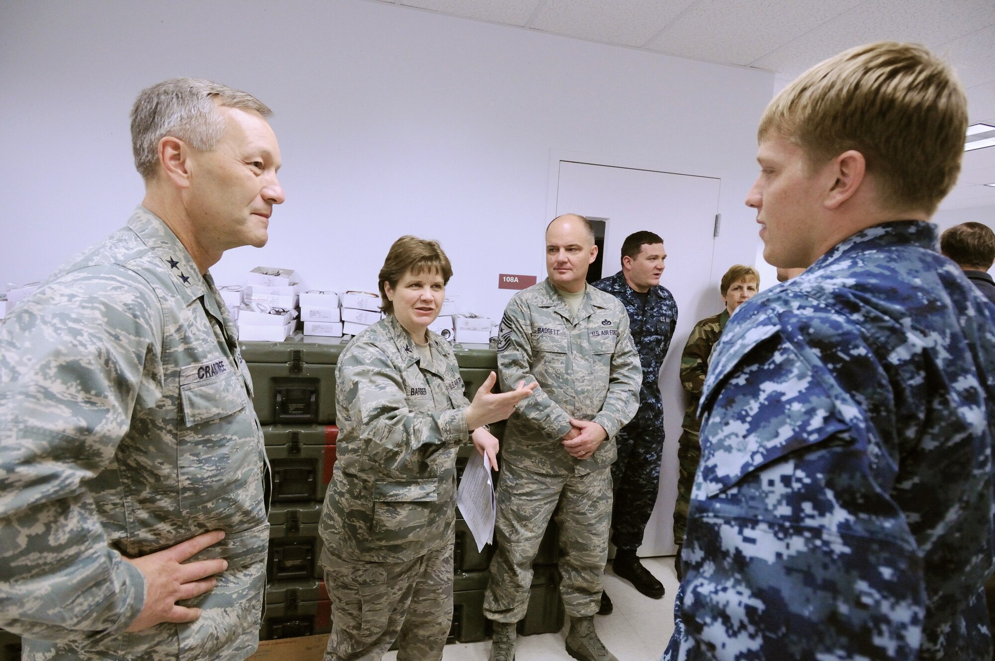 Maj. Gen. Eric W. Crabtree and Col. Christine Barber talk with members of a Navy optometry team April 17, 2010, who are participating in Operation Artic Care in Kotzebue, Alaska.  General Crabtree is the commander of the Air Force Reserve Command's 4th Air Force and Colonel Barber is the Operation Arctic Care project manager. (U.S. Air Force photo/Tech. Sgt. Melissa E. Chatham)
