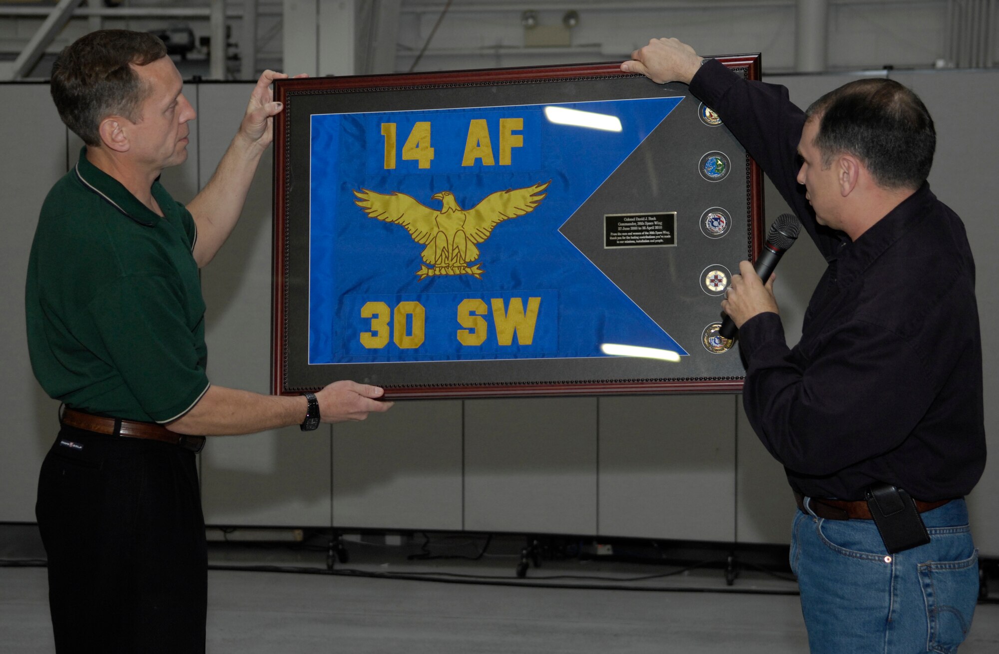 VANDENBERG AIR FORCE BASE, Calif. -- Col. David Buck, the 30th Space Wing commander, receives a going-away gift from Col. Steve Winters, the 30th Space Wing vice commander, during Colonel Buck's farewell dinner  here Friday, April 16, 2010. Colonel Buck's change of command ceremony is scheduled for April 26. (U.S. Air Force photo/Airman 1st Class Andrew Lee)
 
 
 