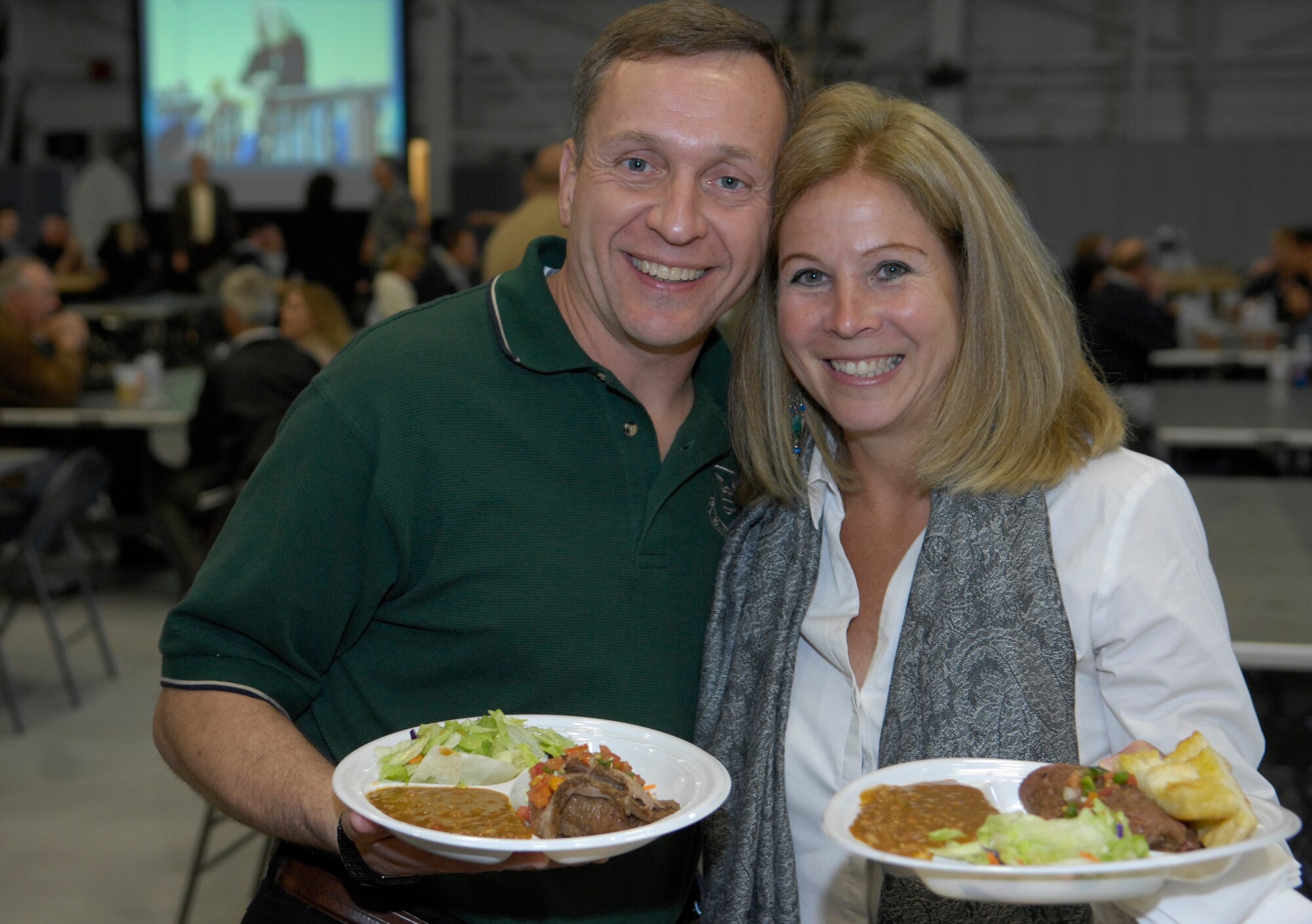 VANDENBERG AIR FORCE BASE, Calif. -- Col. David Buck, the 30th Space Wing commander, and his wife, Mrs. Stella Buck, fill up their plates during Colonel Buck's farewell dinner here Friday, April 16, 2010. The food was cooked and served by Vandenberg's Non-commissioned Officers Association. (U.S. Air Force photo/Airman 1st Class Andrew Lee)
 
 