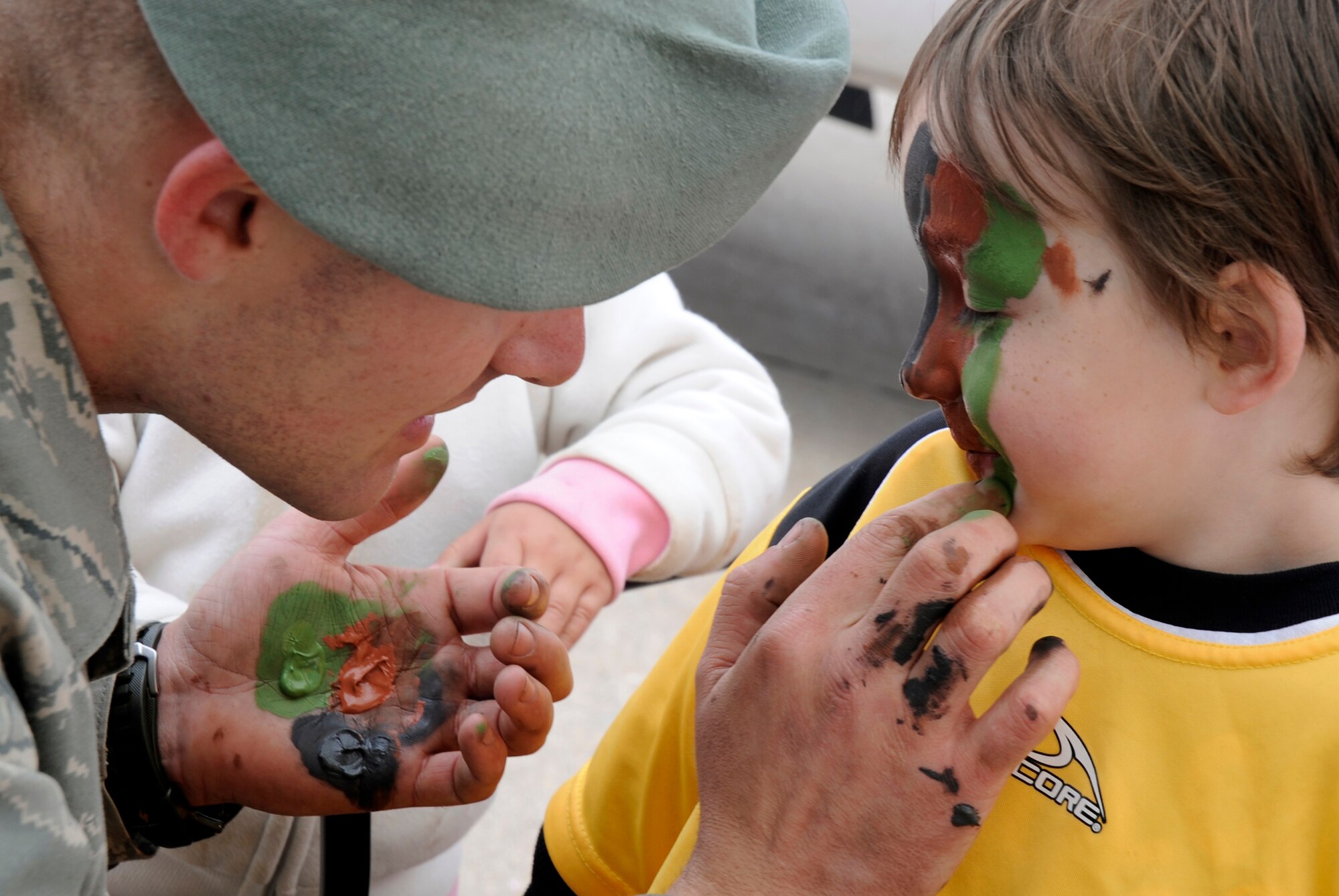 Anthony Bonnes gets his face painted April 17 during a Cannon Air Force Base f open house, the first since the base became home to the 27th Special Operations Wing. from a fighter wing to the 27th Special Operations Wing April 17th. The open house features the 27 SOW and Air Force Special Operations Command personnel, units and assets. (U.S. Air Force photo by Senior Airman Evelyn Chavez)