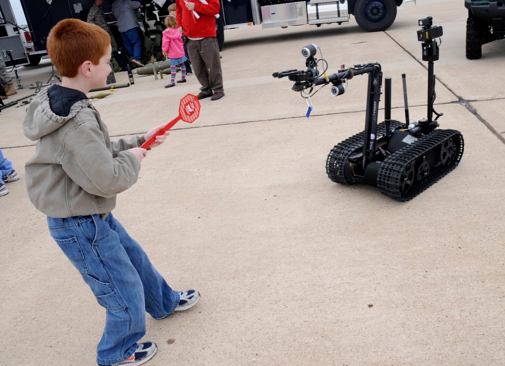 Kegan Rutledge plays with the Talon Robot during an open house at Cannon Air Force Base, N.M. It was the first open house for the base since it became home to the 27th Special Operations Wing in October 2007. (U.S. Air Force photo by Senior Airman Evelyn Chavez)