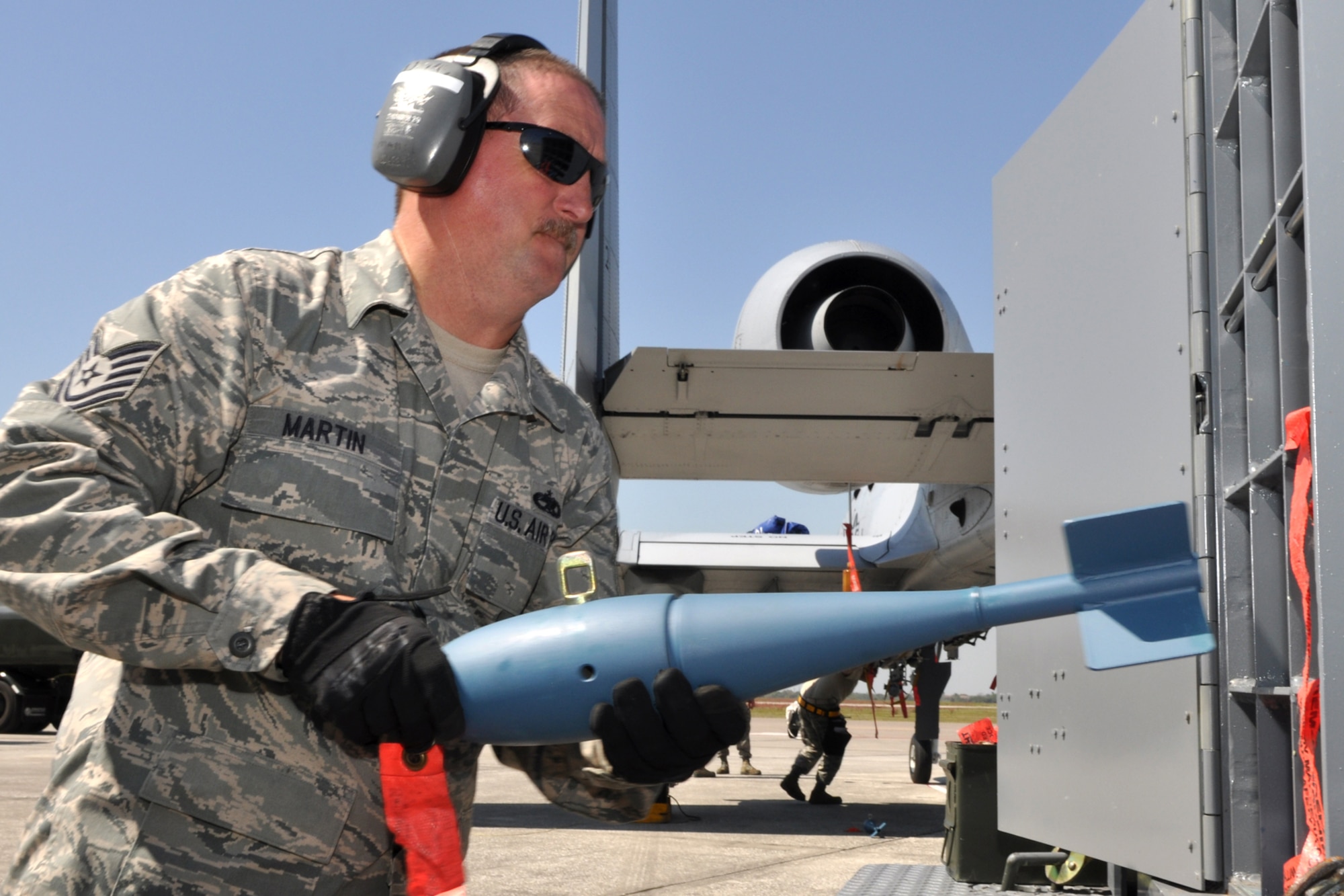 Tech. Sgt. William Martin, a munitions systems mechanic with the 917th Maintenance Squadron, delivers BDU 33 practice bombs to an A -10 Thunderbolt II jet aircraft for loading at MacDill Air Force Base, Fla., April 1, 2010. The practice bomb will disperse a cloud of smoke on impact making it easier to gage the accuracy of the pilot. More than 100 Airmen from the 917th Wing, Barksdale Air Force Base, La., participated in Patriot Everglades, which supported the training of Joint Terminal Attack Controllers (JTAC) and Combat Search and Rescue (CSAR) operations. (U. S. Air Force Photo/Tech. Sgt. Jeff Walston)