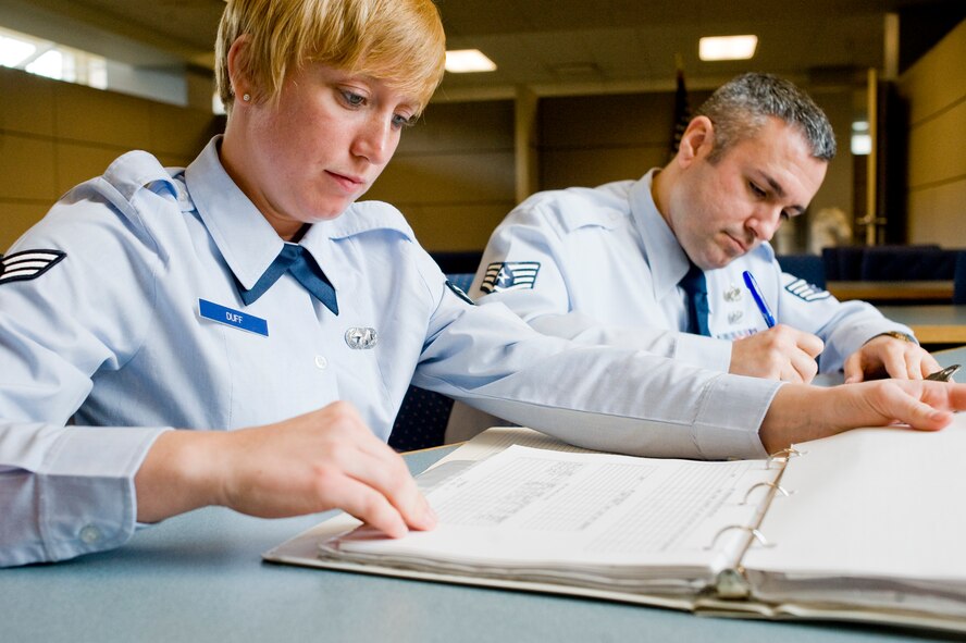 Senior Airman Angela Duff, 62nd Aerial Port Squadron, left, meets with Staff Sgt. Frank D'Angelo, 62nd Maintenance Group, in the Traffic Management Operations office April 19 to complete paperwork and schedule a household goods briefing in preparation for his upcoming permanent change of station. Health benefits from an active lifestyle will increase productivity, optimize health, and decrease absenteeism while maintaining a higher level of readiness. (U.S. Air Force Photo by Abner Guzman)