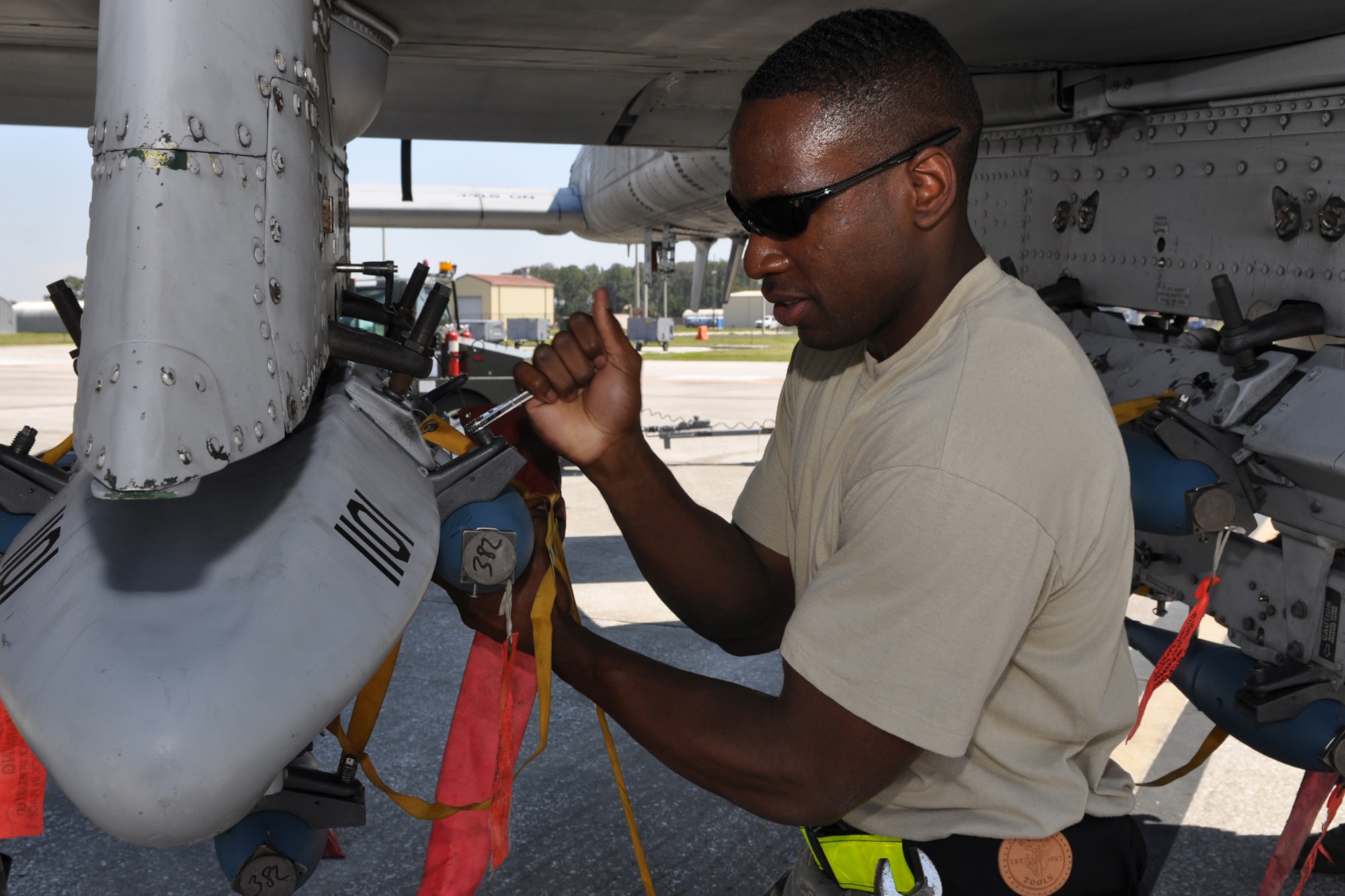 Senior Airman Charles Wilson, aircraft armament systems mechanic, 717th Aircraft Maintenance Squadron, from Barksdale Air Force Base, La., loads a BDU 33 practice bomb on a bomb rack under the wing of an A-10 Thunderbolt II jet aircraft at MacDill Air Force Base, Fla., April 1, 2010. The practice bomb will disperse a cloud of smoke on impact making it easier to gage the accuracy of the pilot. More than 100 Airmen from the 917th Wing, Barksdale Air Force Base, La., participated in Patriot Everglades, which supported the training of Joint Terminal Attack Controllers (JTAC) and Combat Search and Rescue (CSAR) operations. (U. S. Air Force Photo/Tech. Sgt. Jeff Walston)