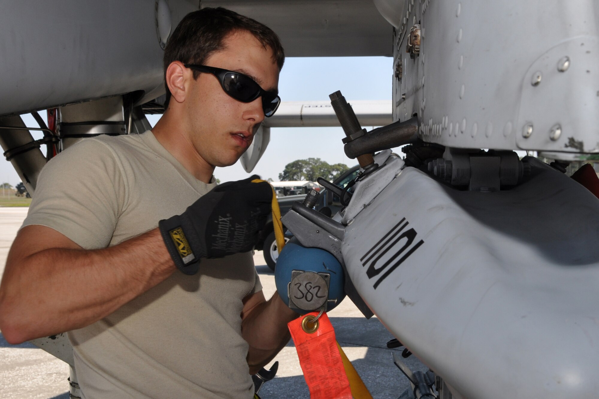 Senior Airman Josh Amburn and Charles Wilson, both aircraft armament systems mechanics with the 717th Aircraft Maintenance Squadron, from Barksdale Air Force Base, La., install a triple-ejection rack under the wing of an A-10 Thunderbolt II at MacDill Air Force Base, Fla., April 1, 2010. More than 100 Airmen from the 917th Wing, Barksdale Air Force Base, La., participated in Patriot Everglades, which supported the training of Joint Terminal Attack Controllers (JTAC) and Combat Search and Rescue (CSAR) operations. (U. S. Air Force Photo/Tech. Sgt. Jeff Walston)
