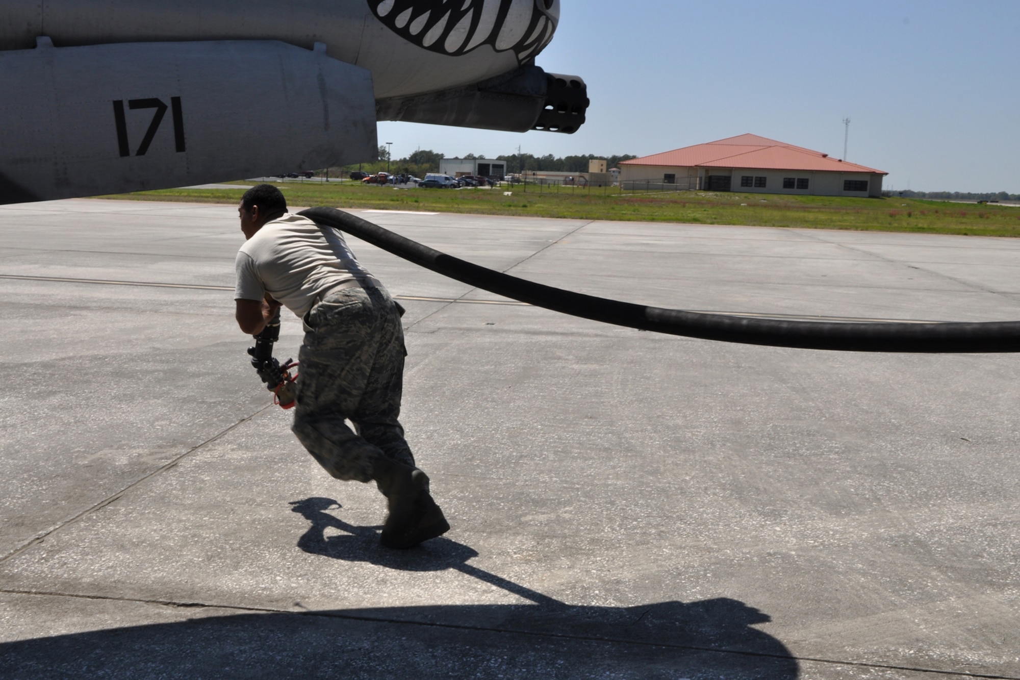 Tech. Sgt. Derrick Latson, liquid fuels operator, 917th Logistics Readiness Squadron, pulls the refueling hose to an A-10 Thunderbolt II at MacDill Air Force Base, Fla., April 1, 2010. More than 100 Airmen from the 917th Wing, Barksdale Air Force Base, La., participated in Patriot Everglades, which supported the training of Joint Terminal Attack Controllers (JTAC) and Combat Search and Rescue (CSAR) operations. (U. S. Air Force Photo/Tech. Sgt. Jeff Walston)