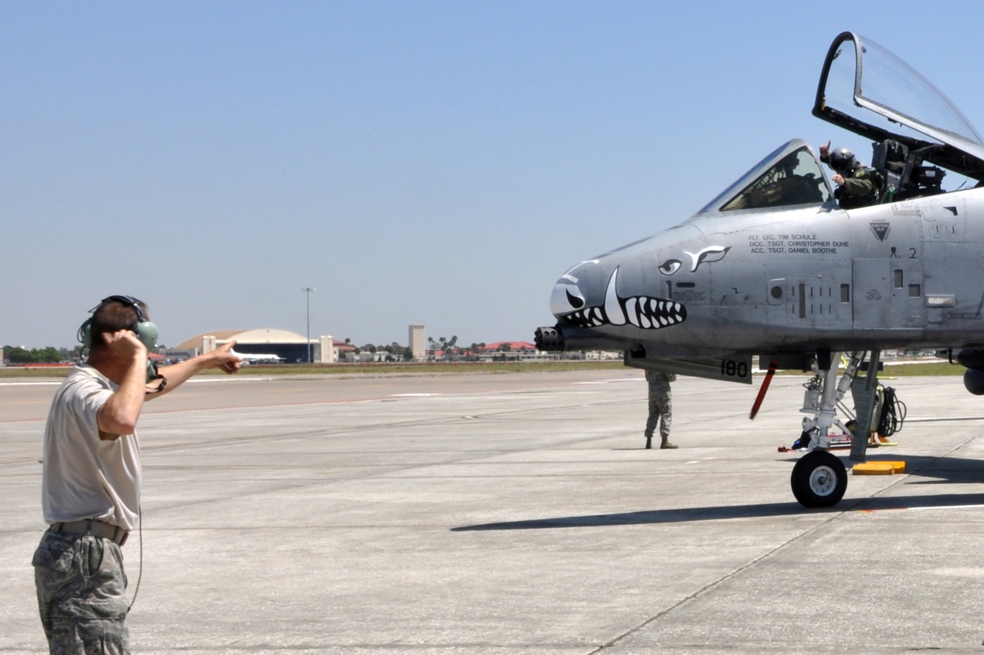 Lt. Col. James Macaulay, deputy commander, 917th Operations Group, responds to the directions of Technical Sgt. Christopher Duhe to throttle up and prepare to taxi his aircraft at MacDill Air Force Base, Fla., April 1, 2010.  Sergeant Duhe, a crew chief for the 717th Aircraft Maintenance Squadron and Colonel Macaulay, are just two of the more than 100 Airmen from the 917th Wing, Barksdale Air Force Base, La., who participated in Patriot Everglades, which supported the training of Joint Terminal Attack Controllers (JTAC) and Combat Search and Rescue (CSAR) operations. (U. S. Air Force Photo/Tech. Sgt. Jeff Walston)