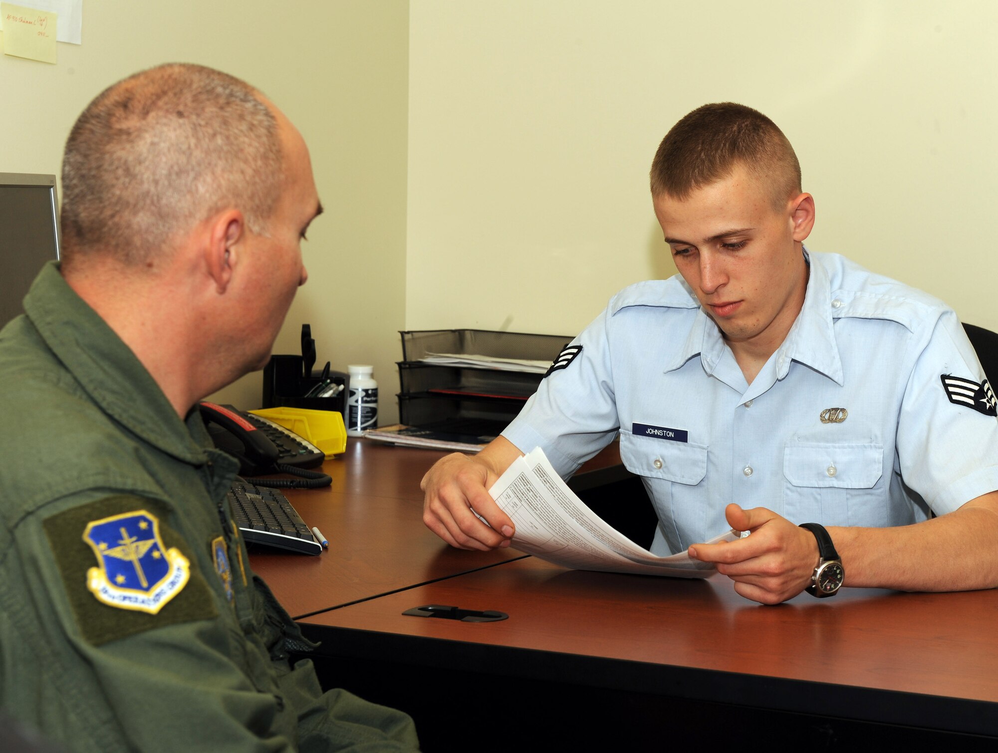 Senior Airman Cody Johnston (right), 61st Airlift Squadron aviation resource management specialist, and Master Sgt. Michael Jinkins (left), 61st AS flight engineer, review flight mission paperwork for discrepancies April 19. The paperwork reviewed by Airman Johnston will be used to log the required training and flight hours for Sergeant Jinkins.  (U.S. Air Force photo by Staff Sgt. Chad Chisholm)
