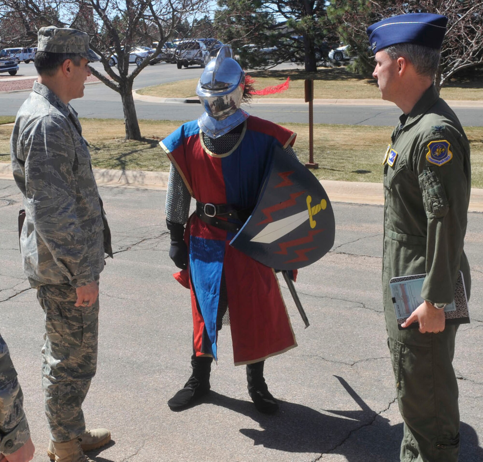 PETERSON AIR FORCE BASE, Colo. -- Col. Bradford Shwedo (left), 67th Network Warfare Wing commander, Lackland Air Force Base, Texas, and Col. Stephen N. Whiting, 21st Space Wing commander, meet with the 21st SW’s Iron Mike in front of The Club April 9. With the newly-formed 24th Air Force participating in Guardian Challenge for the first time, the 21st SW and 67th NWW have been paired as sister wings. Colonel Shwedo spent the day touring 21st SW units and discussing the integration of space and cyber capabilities. (U.S. Air Force photo/Robb Lingley)