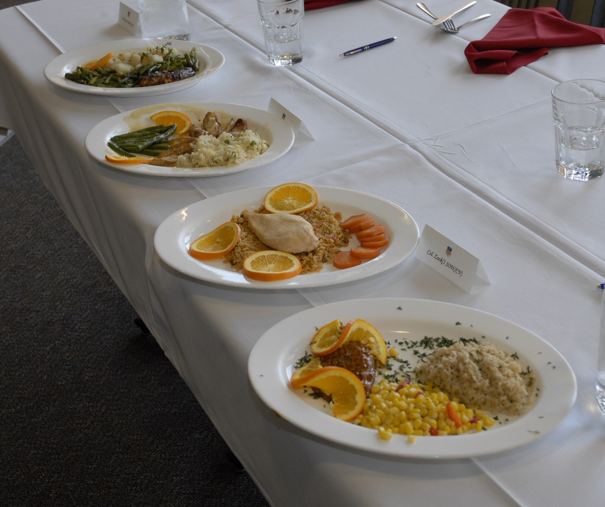 The four select orange and chicken dishes sit on display for voting for the chef of the quarter competition at the Riptide dining facility at Hurlburt Field April 13. A panel of four judges sampled the dishes and picked them based on their taste, presentation, creativity and originality. (DoD photo by U.S. Air Force Airman 1st Class Joe McFadden) (Released)