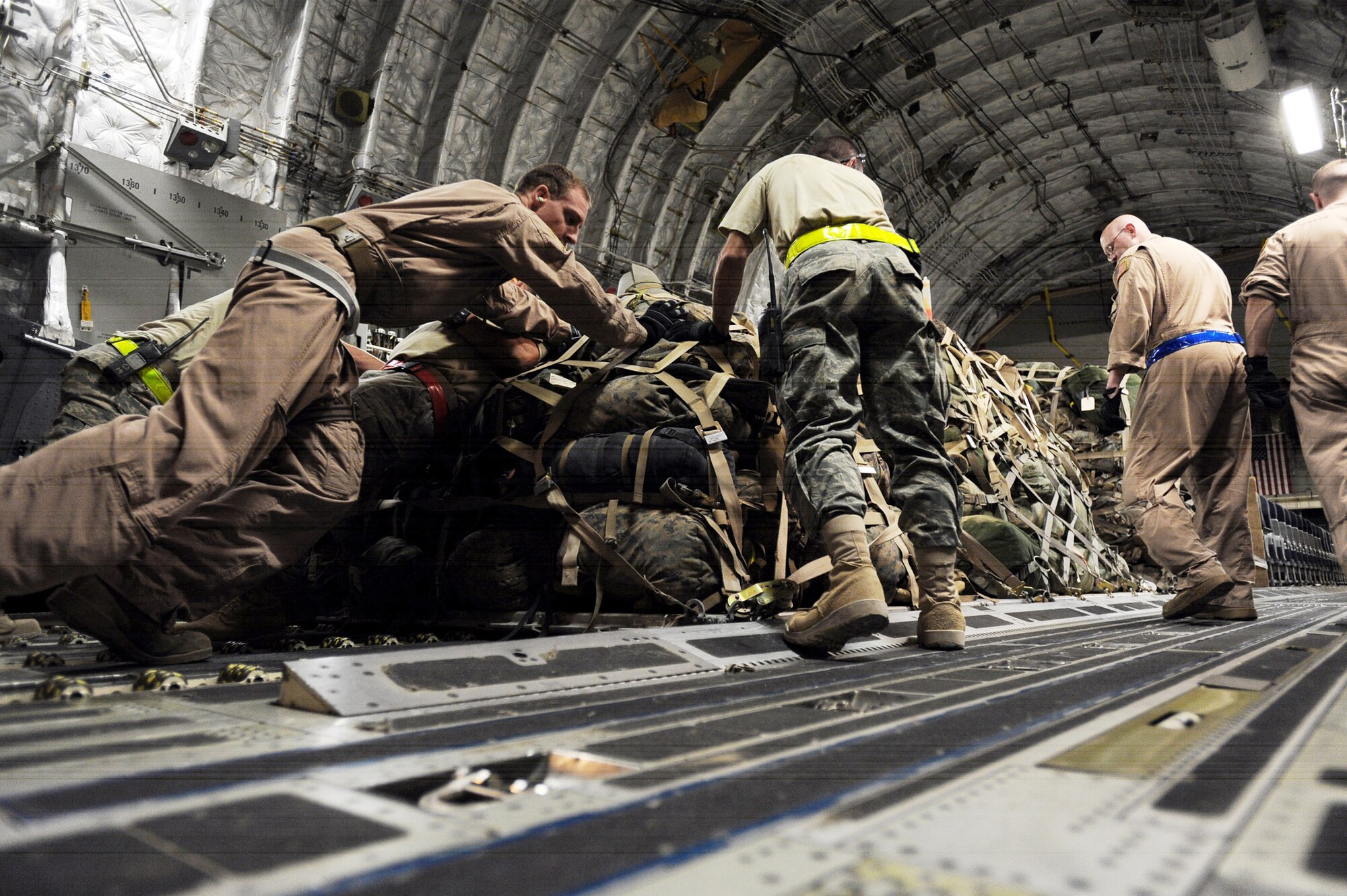 Aerial porters assigned to the 451st Expeditionary Logistics Readiness Squadron Det. 1 and C-17 Globemaster III loadmasters assigned to the 816th Expeditionary Airlift Squadron load pallets of luggage that belong to 157 Marines boarding the aircraft April 15, 2010, at Camp Bastion, Afghanistan. (U.S. Air Force photo/Staff Sgt. M. Julian Martinez)