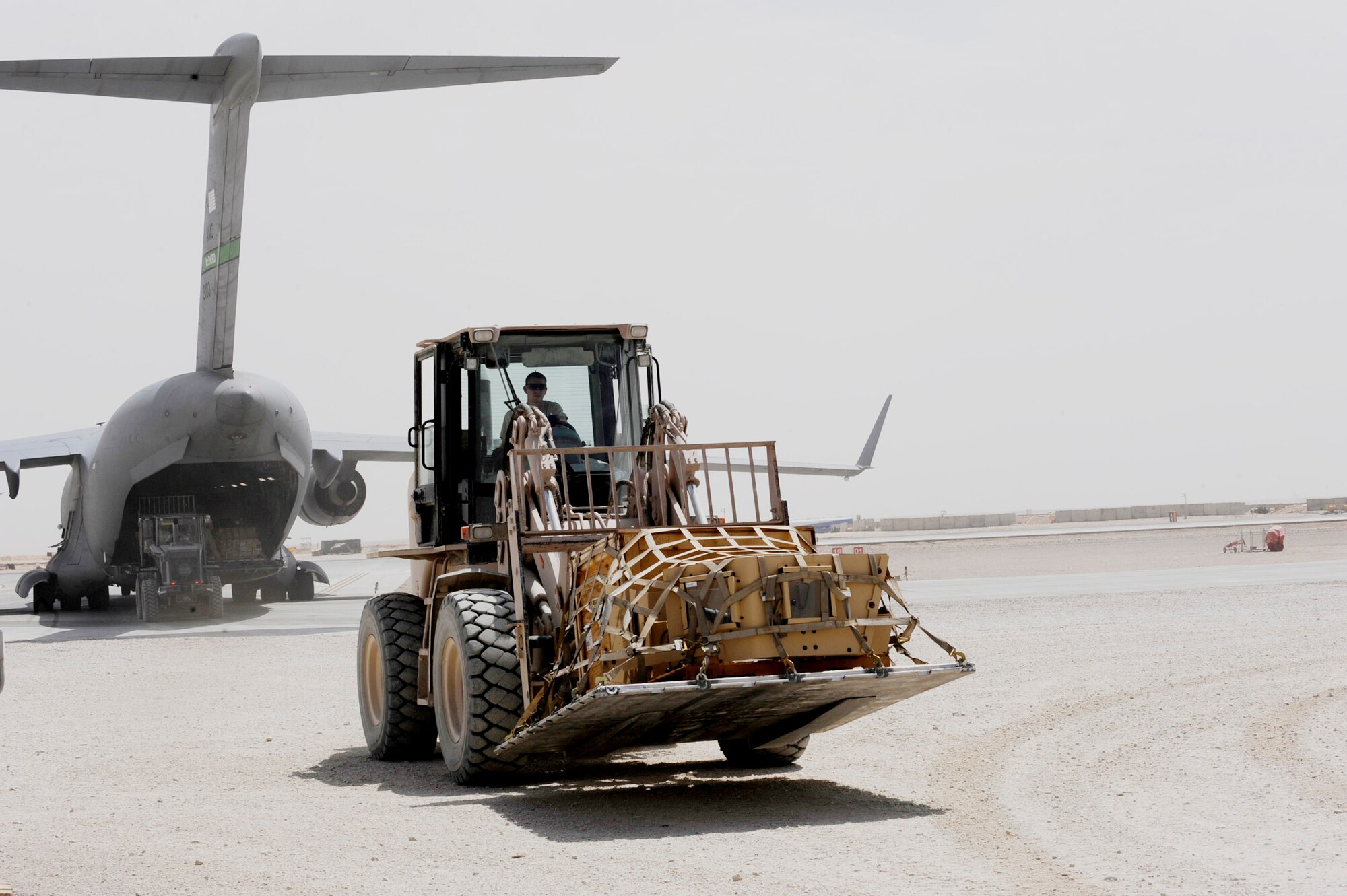 Aerial porters assigned to the 451st Expeditionary Logistics Readiness Squadron Det. 1 offload pallets from a C-17 Globemaster III assigned to the 10th Airlift Squadron at McChord Air Force Base, Wash., with a 10k all-terrain forklift April 15, 2010, at Camp Bastion, Afghanistan. (U.S. Air Force photo/Staff Sgt. M. Julian Martinez)