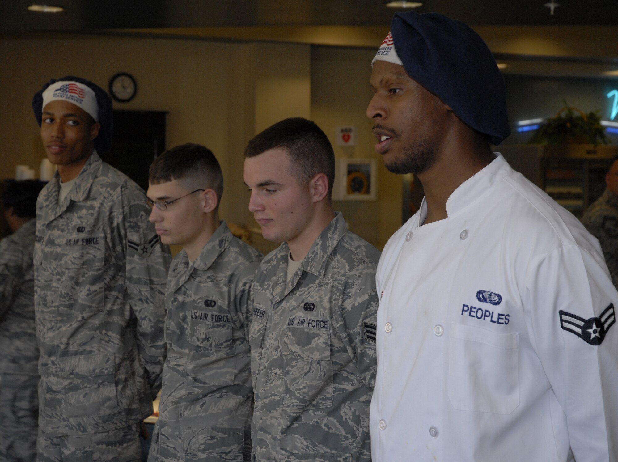Airman 1st Class Jeffrey Peoples,1st Special Operations Force Support Squadron, far right, talks to the panel about his meal as fellow 1st SOFSS chefs (left to right) Airman 1st Class Nicholas McCants, Airman 1st Class James Bloodworth and Senior Airman James Schneider look on during the chef of the quarter competition at the Riptide dining facility at Hurlburt Field April 13. A panel of four judges sampled the dishes and picked them based on their taste, presentation, creativity and originality. (DoD photo by U.S. Air Force Airman 1st Class Joe McFadden) (Released)