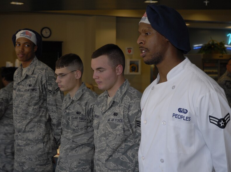 Airman 1st Class Jeffrey Peoples,1st Special Operations Force Support Squadron, far right, talks to the panel about his meal as fellow 1st SOFSS chefs (left to right) Airman 1st Class Nicholas McCants, Airman 1st Class James Bloodworth and Senior Airman James Schneider look on during the chef of the quarter competition at the Riptide dining facility at Hurlburt Field April 13. A panel of four judges sampled the dishes and picked them based on their taste, presentation, creativity and originality. (DoD photo by U.S. Air Force Airman 1st Class Joe McFadden) (Released)