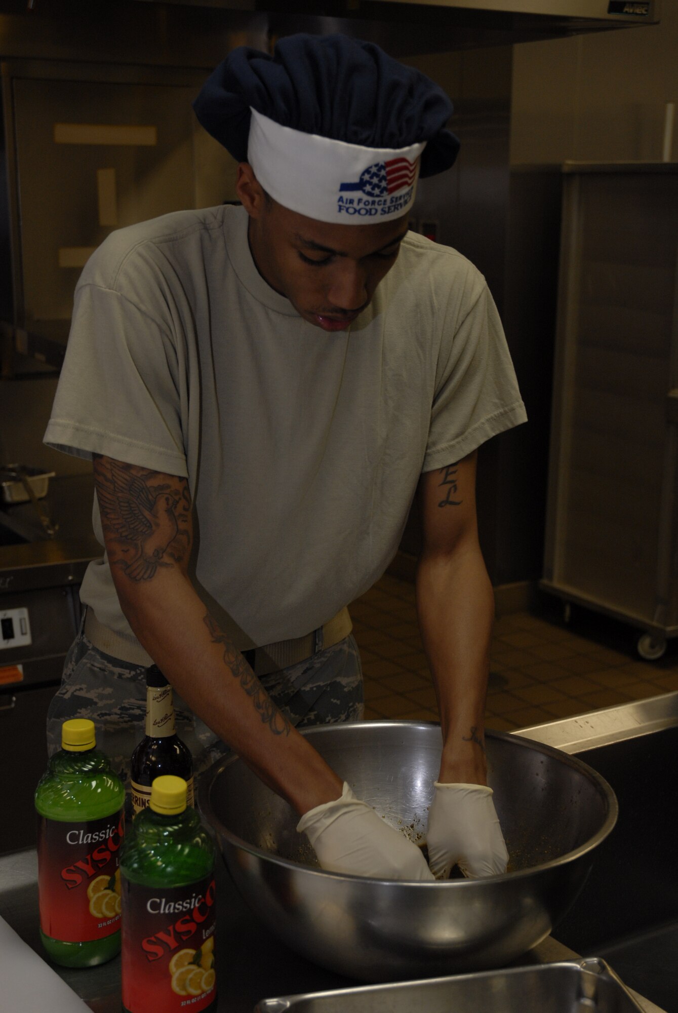 Airman 1st Class Nicholas McCants, 1st Special Operations Force Support Squadron, marinates a chicken breast during the chef of the quarter competition at the Riptide dining facility at Hurlburt Field April 13. A panel of four judges sampled the dishes and picked them based on their taste, presentation, creativity and originality. (DoD photo by U.S. Air Force Airman 1st Class Joe McFadden) (Released)
