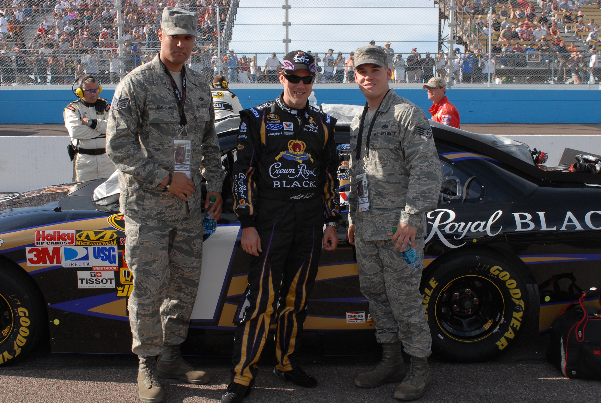 Staff Sgts. Damon Thurman (right) and Charlton Dubose, 56th Maintenance Group quality assurance inspectors, pose with Matt Kenseth, NASCAR driver Saturday, April 10 during the Subway Fresh Fit 600 NASCAR race at the Phoenix International Raceway. (Photo by Airman 1st Class Sandra Welch)