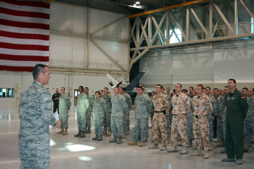 CREECH AFB, Nev. -- Colonel Pete Gersten, 432d Wing and 432d Air Expeditionary Wing commander, speaks to Hunter Airmen during the wing commander's call here April 14. Colonel Gersten took time out to address Airmen on the Air Force's recent Force Management Initiatives. Air Force leaders announced March 25 an expansion of force management measures designed to bring the Air Force within its congressionally mandated end strength. For more information on force management options call the Total Force Service Center at 800-525-0102 or visit the Air Force Personnel Center Web site at https://gum.afpc.randolph.af.mil/cgi-bin/askafpc.cfg/php/enduser/home.php?p_sid=pf8ohfXj&p_accessibility=0&p_redirect . (U.S. Air Force Photo by Staff Sgt. Alice Moore) 