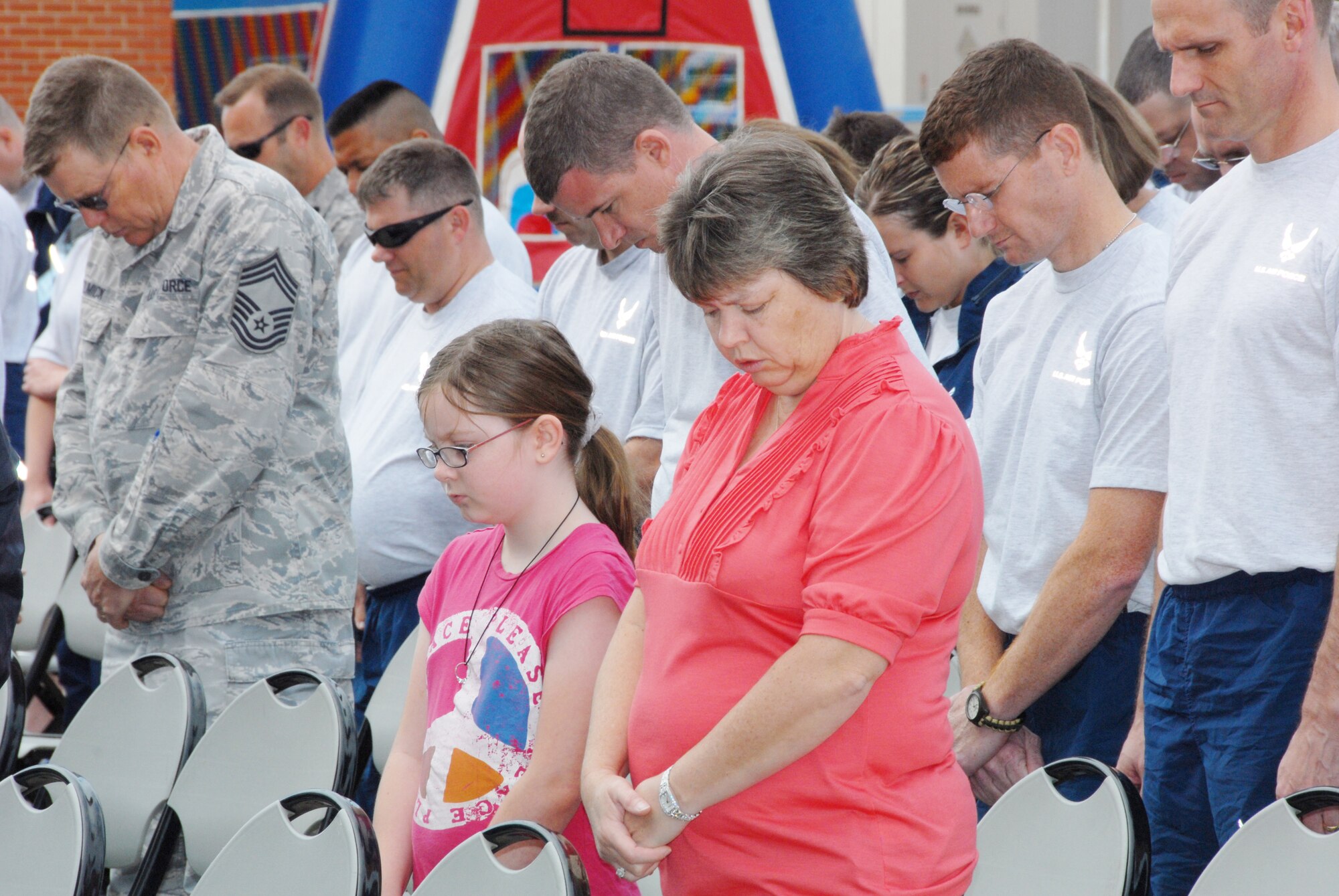 The men and women of the 189th Airlift Wing and their families bow their heads in prayer during the Hometown Heroes event. (U.S. Air Force photo by Staff Sgt. Julian Johnson)
