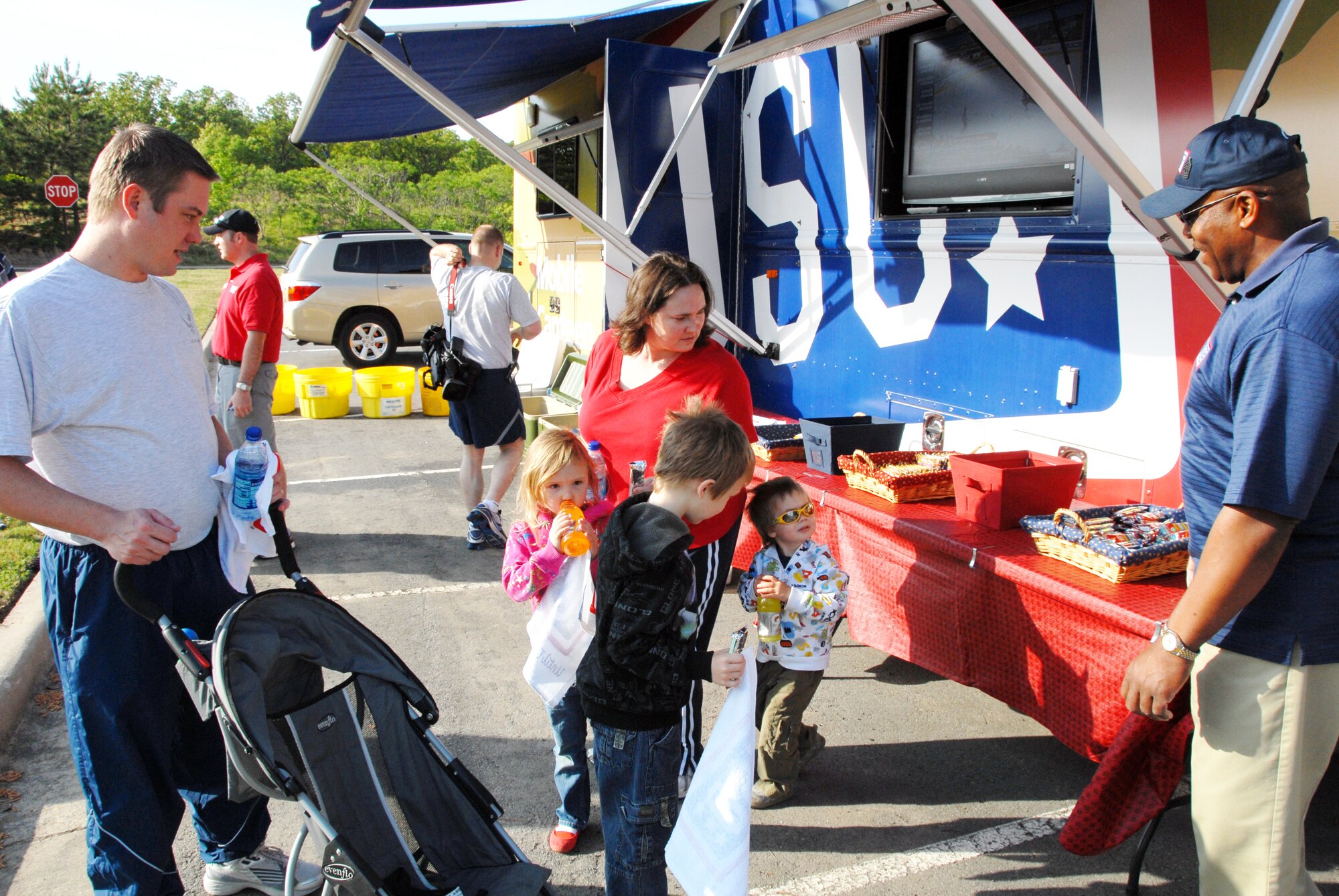 John Brunson, USO representative, watches as Tech. Sgt. Kenneth Martin, 189th Force Support Squadron, and his family, take a short break from the Suicide Awareness walk. The USO provided snacks and drinks for the incoming walkers. (U.S. Air Force photo by Staff Sgt. Julian Johnson)