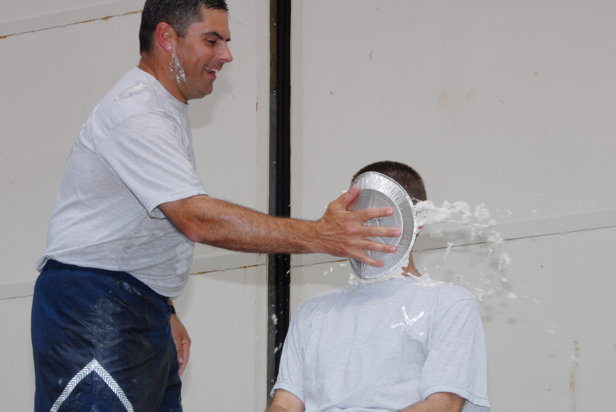 Lt. Col. Charles Nichols, 189th Force Support Squadron commander, gives Maj. Mitch Long, 189th Logistic Readiness Squadron commander, a pie in the face in one of the events during family day. (U.S. Air Force photo by Staff Sgt. Julian Johnson)