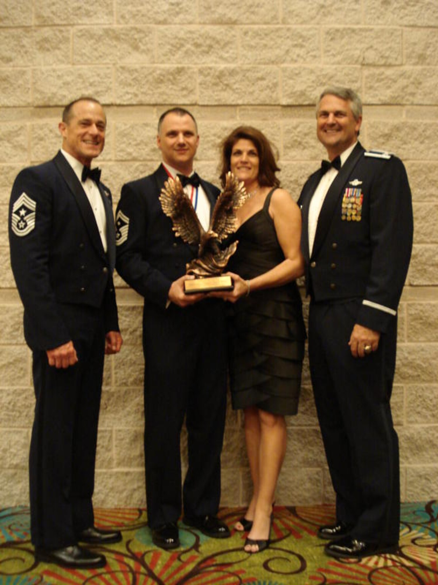 Senior Master Sgt. Mark Barber, 81st Aerial Port Squadron First Sergeant, and his wife Pam, were joined by Colonel Mike Speer and Command Chief Master Sergeant Ben Futrell from the 315th Airlift Wing, Charleston Air Force Base S.C. at the Air Force Reserve Command banquet April 14. SMSgt Barber won the award for First Sergeant of the Year and will now compete at the Air Force level for the 12 Outstanding Airmen of the Year. 

