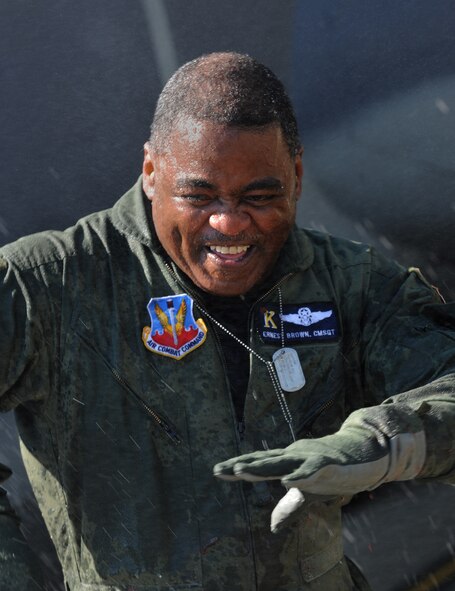 MOODY AIR FORCE BASE, Ga. -- Chief Master Sgt. Ernest Brown, 71st Rescue Squadron chief enlisted manager, is hosed off with a fire truck after his fini-flight here April 2. Chief Brown flew more than 6,000 hours during his career as a C-130 loadmaster. (U.S. Air Force photo by Airman 1st Benjamin Wiseman/RELEASED)