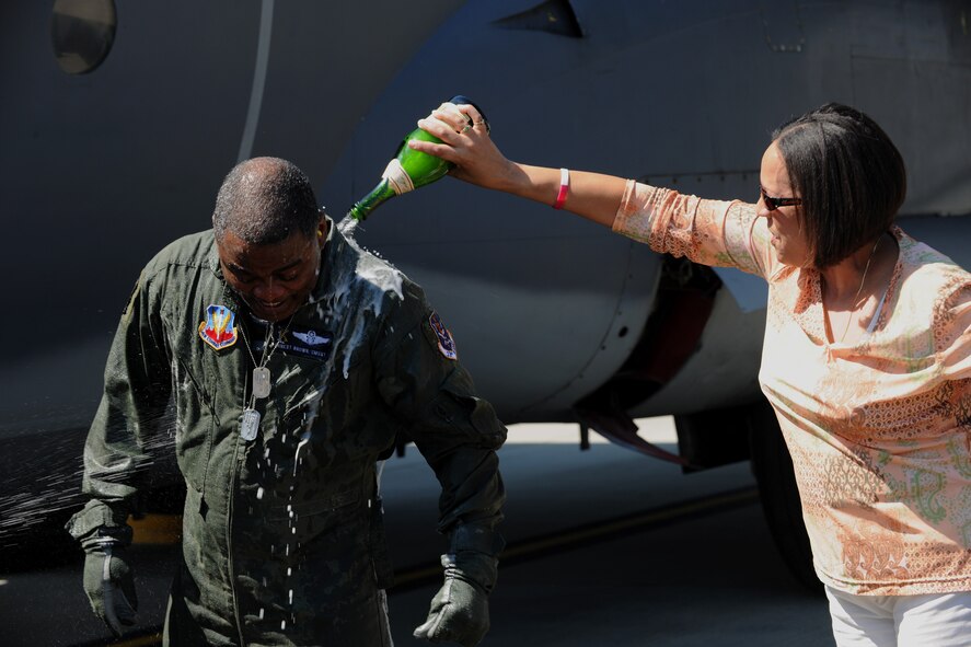 MOODY AIR FORCE BASE, Ga. -- Chief Master Sgt. Ernest Brown, 71st Rescue Squadron chief enlisted manager, gets drenched with champagne by his wife Judith after his fini-flight here April 2. Chief Brown will be retiring after 30 years of military service. (U.S. Air Force photo by Airman 1st Class Benjamin Wiseman/RELEASED)