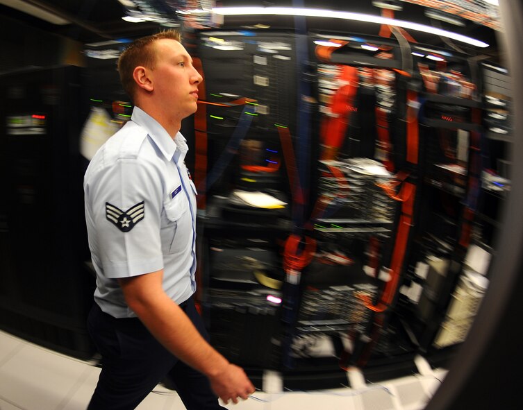OFFUTT AIR FORCE BASE, Neb. - Senior Airman Dustin Scott, a network infrastructure technician assigned to the Air Force Weather Agency's 2d Systems Operations Squadron here, performs routine observation and maintenance of AFWA's network April 19. Airman Scott was recently announced as the Communications and information Outstanding Communications-Computer Systems award winner. Airman Scott will accept the award in a formal ceremony in Washington D.C., next month. U.S. Air Force photo by Josh Plueger